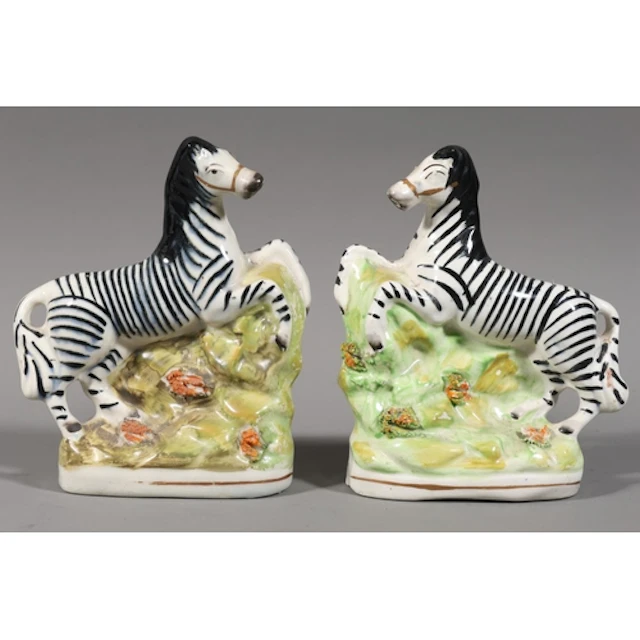 Pair of Staffordshire style pottery models of zebras, 17cm t...