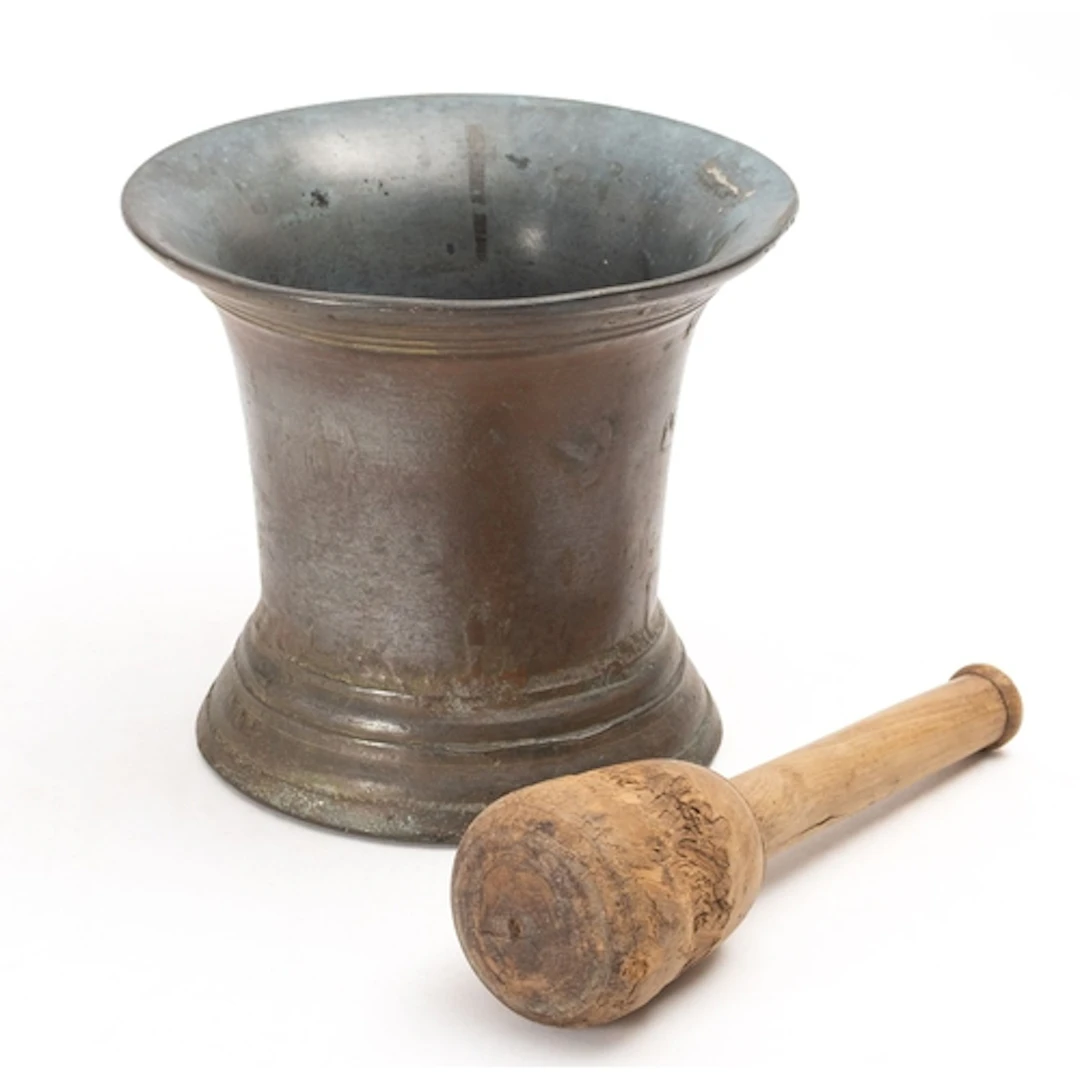 A 19th Century large bronze mortar and wooden pestle. Of con...