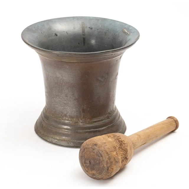 A 19th Century large bronze mortar and wooden pestle. Of con...