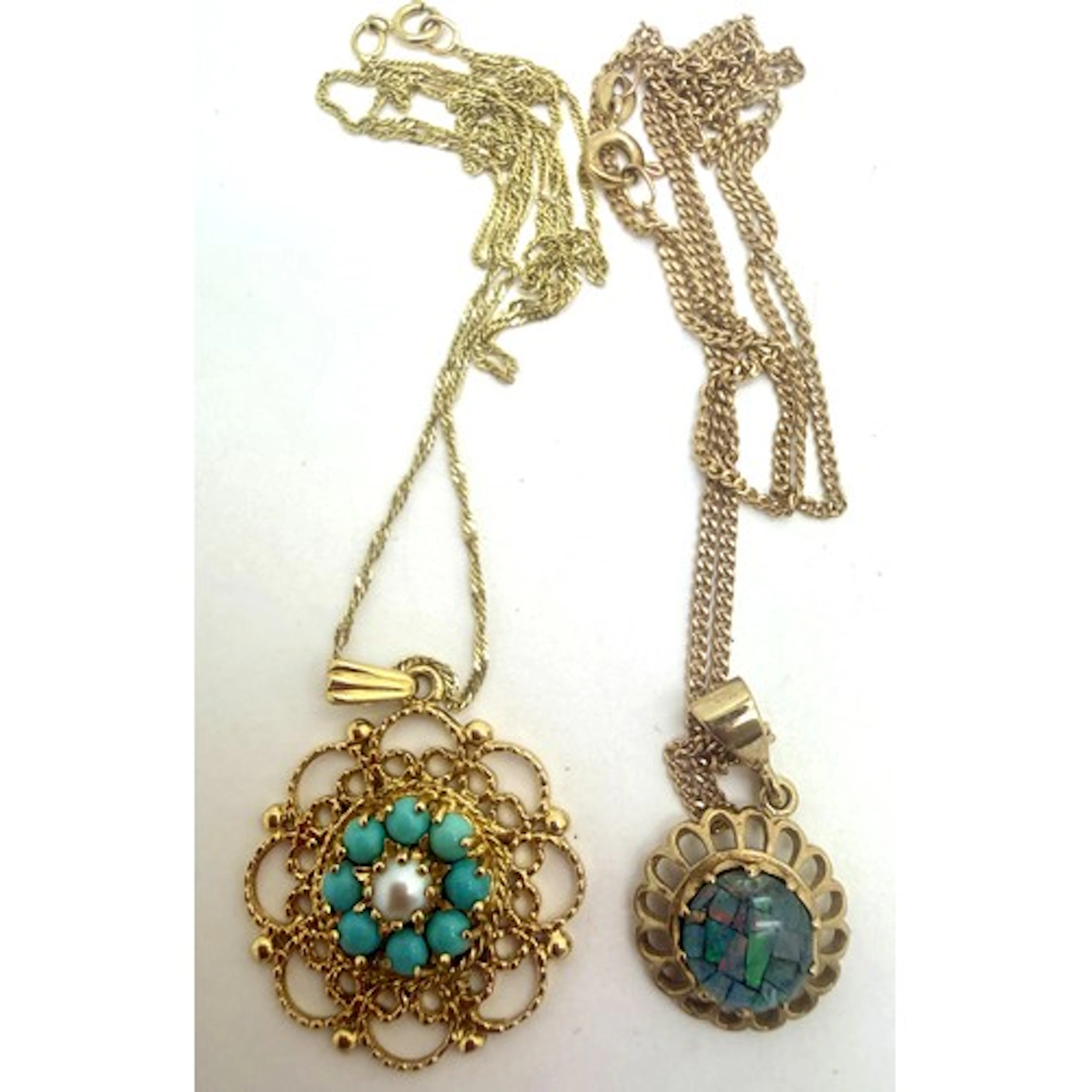 Two 9 carat gold pendants on 9 carat gold chains, one set wi...