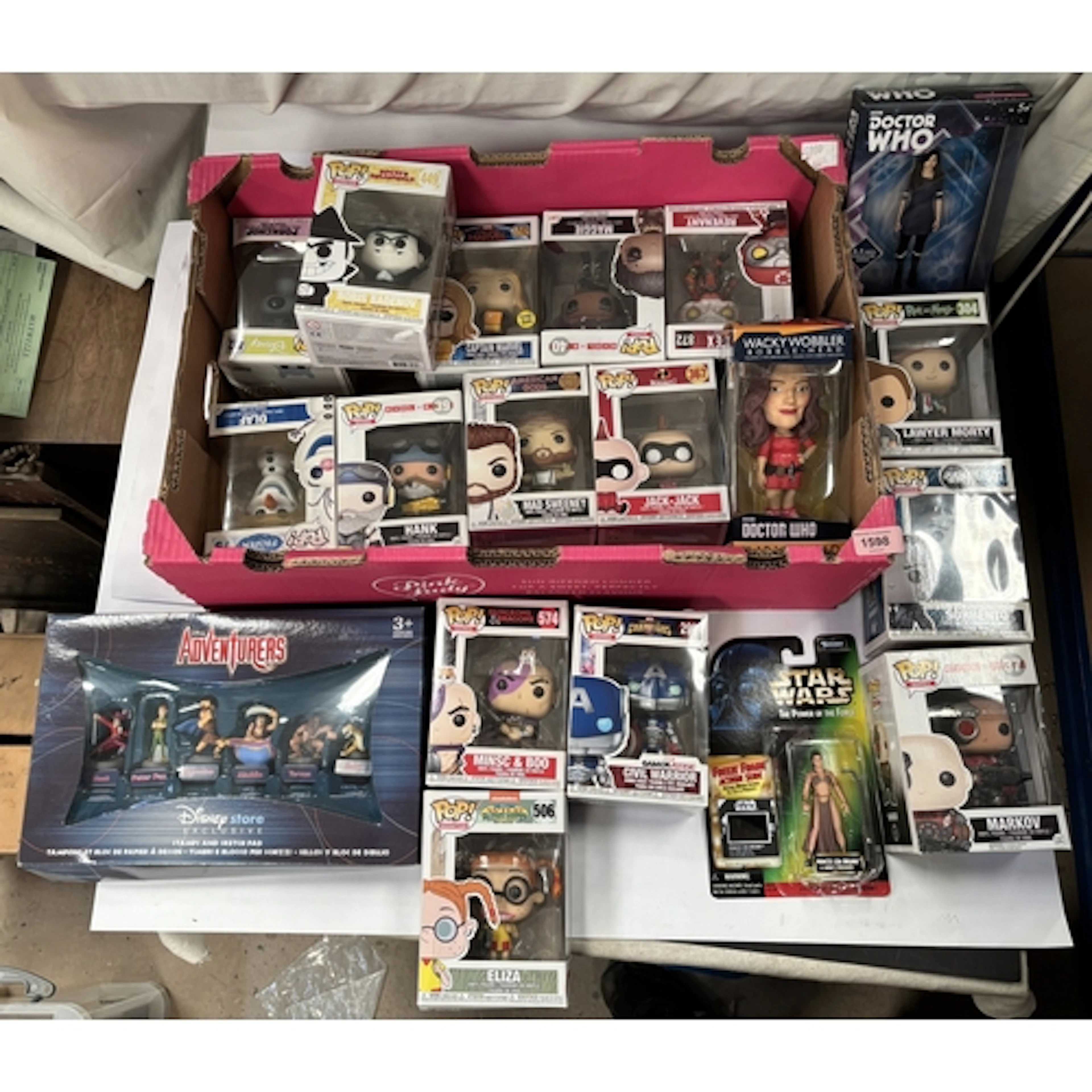 A collection of Funko Pops and other toys etc