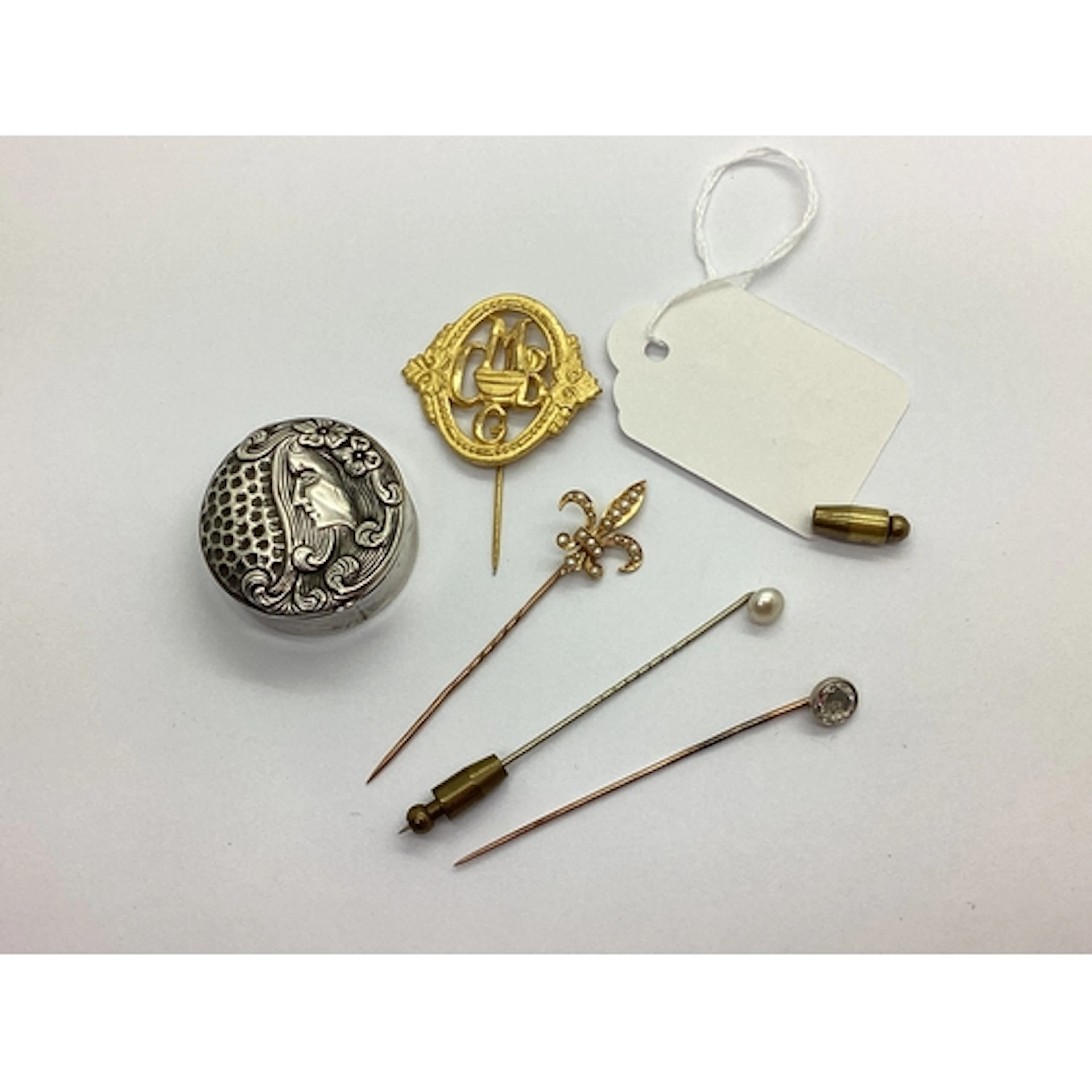 An Antique Fleur De Lis Stick Pin, with seed pearl highlight...