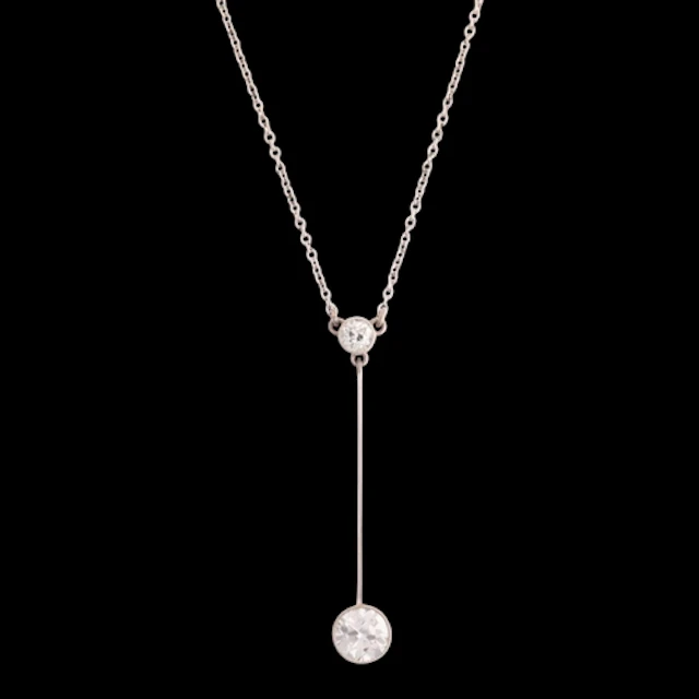 An Edwardian palladium and platinum two stone diamond pendan...