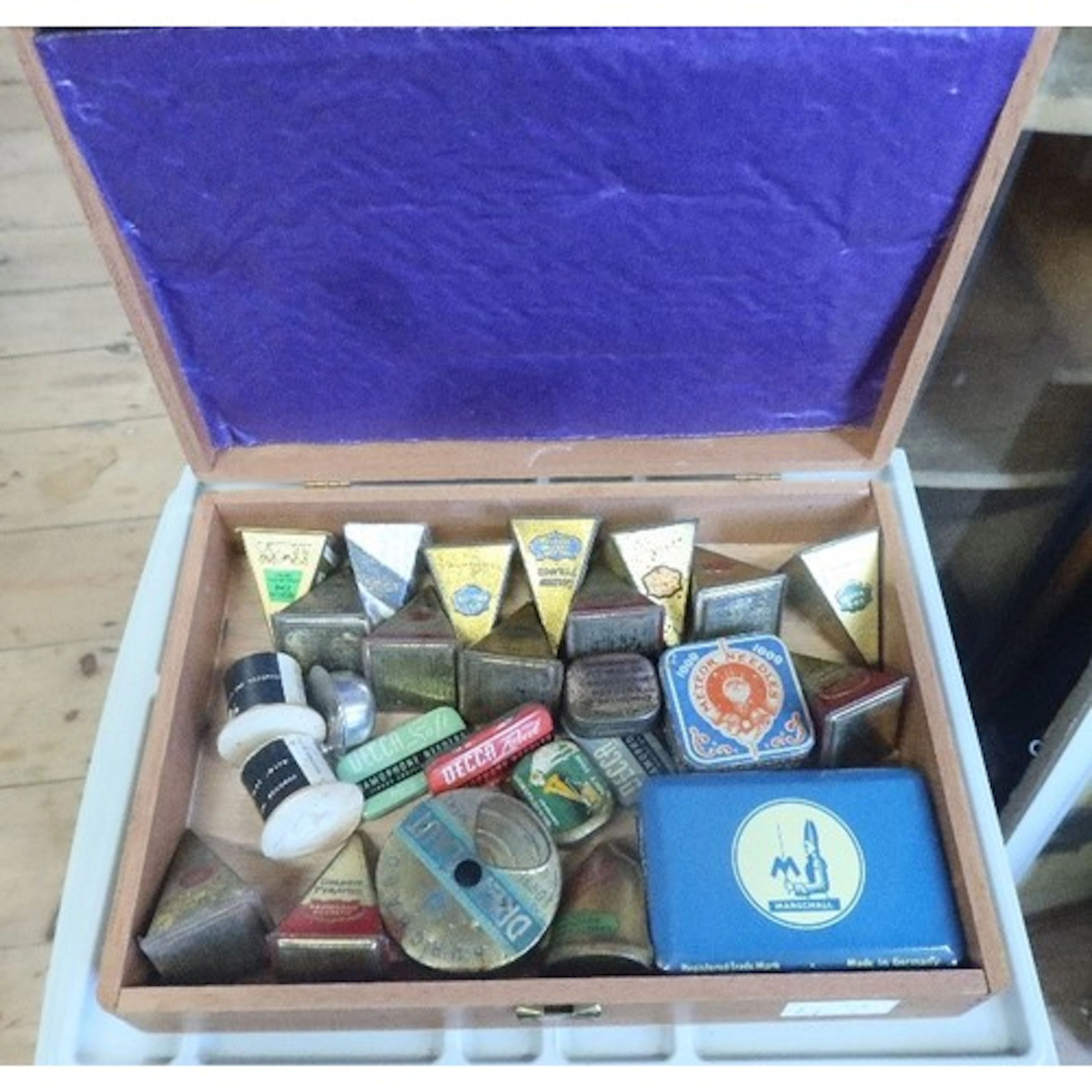 A box of vintage gramophone needle tins