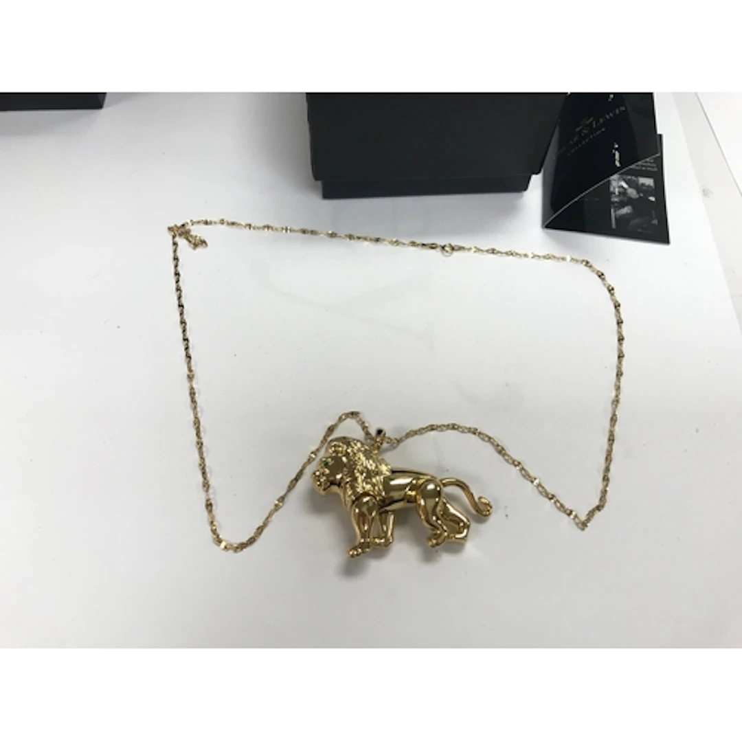 An Oscar and Lewis gold plated lion on a 9ct gold chain.