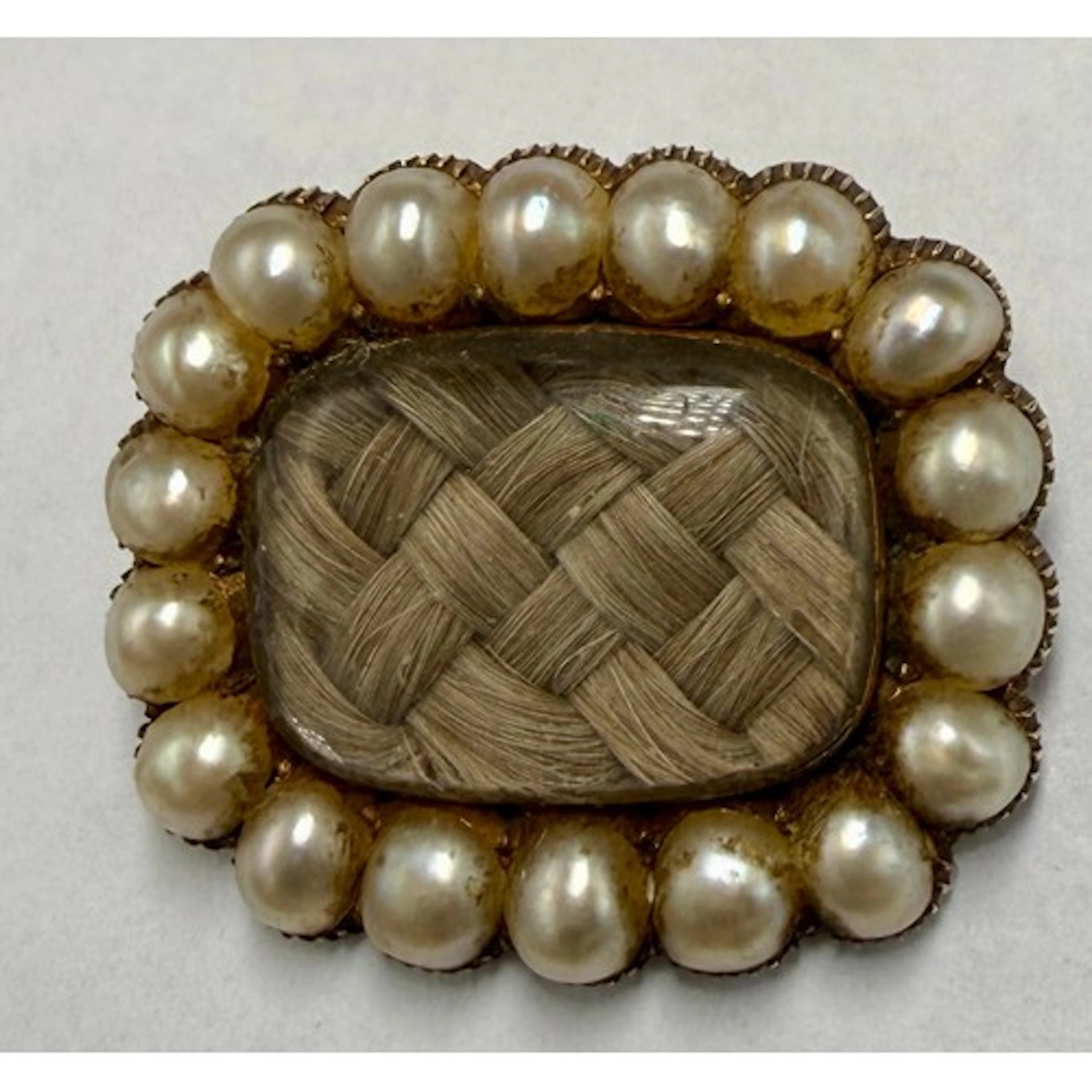 A 19thC seed pearl and hair mourning brooch set in unmarked ...