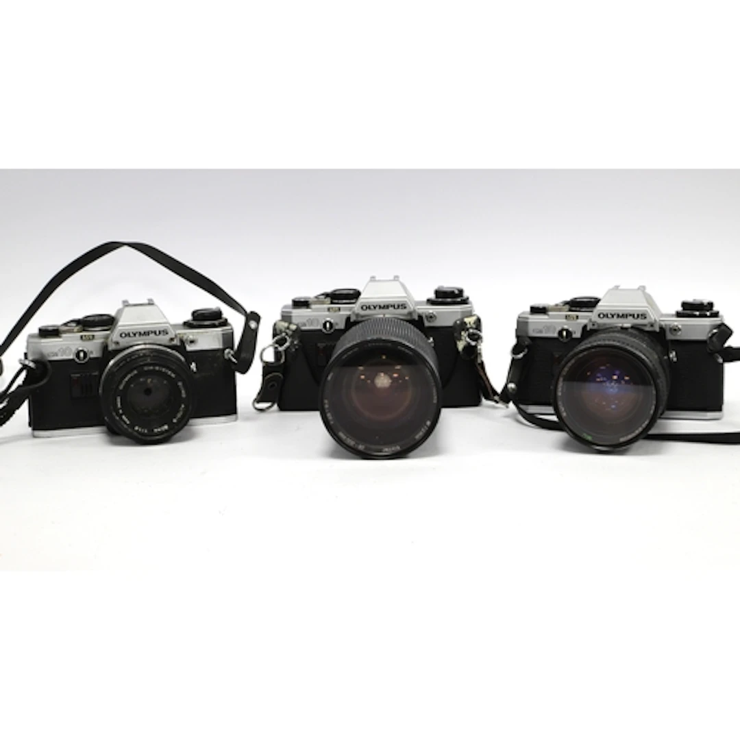 Olympus OM10 35mm SLR Film Cameras one with attached Zuiko A...