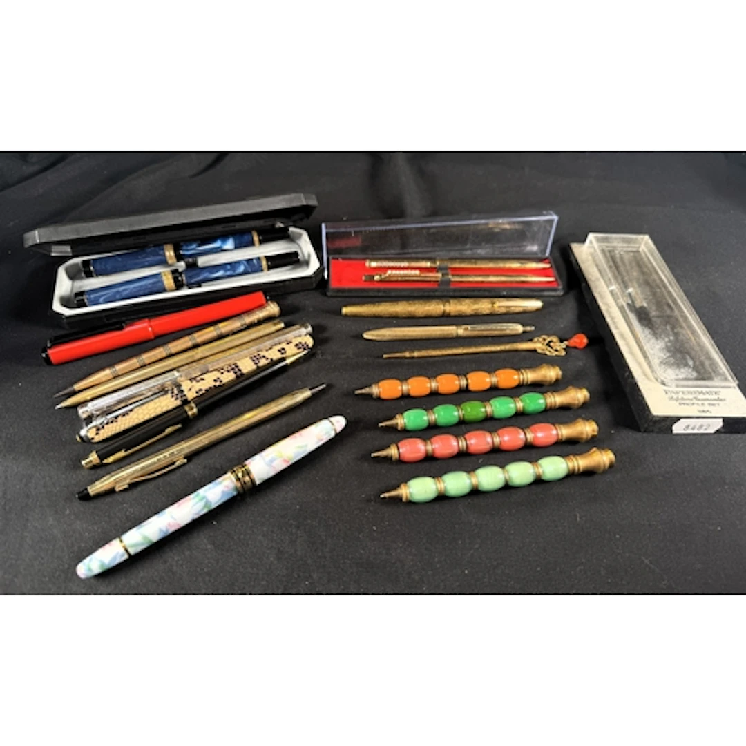 A selection of vintage fountain pens, biros and pencils