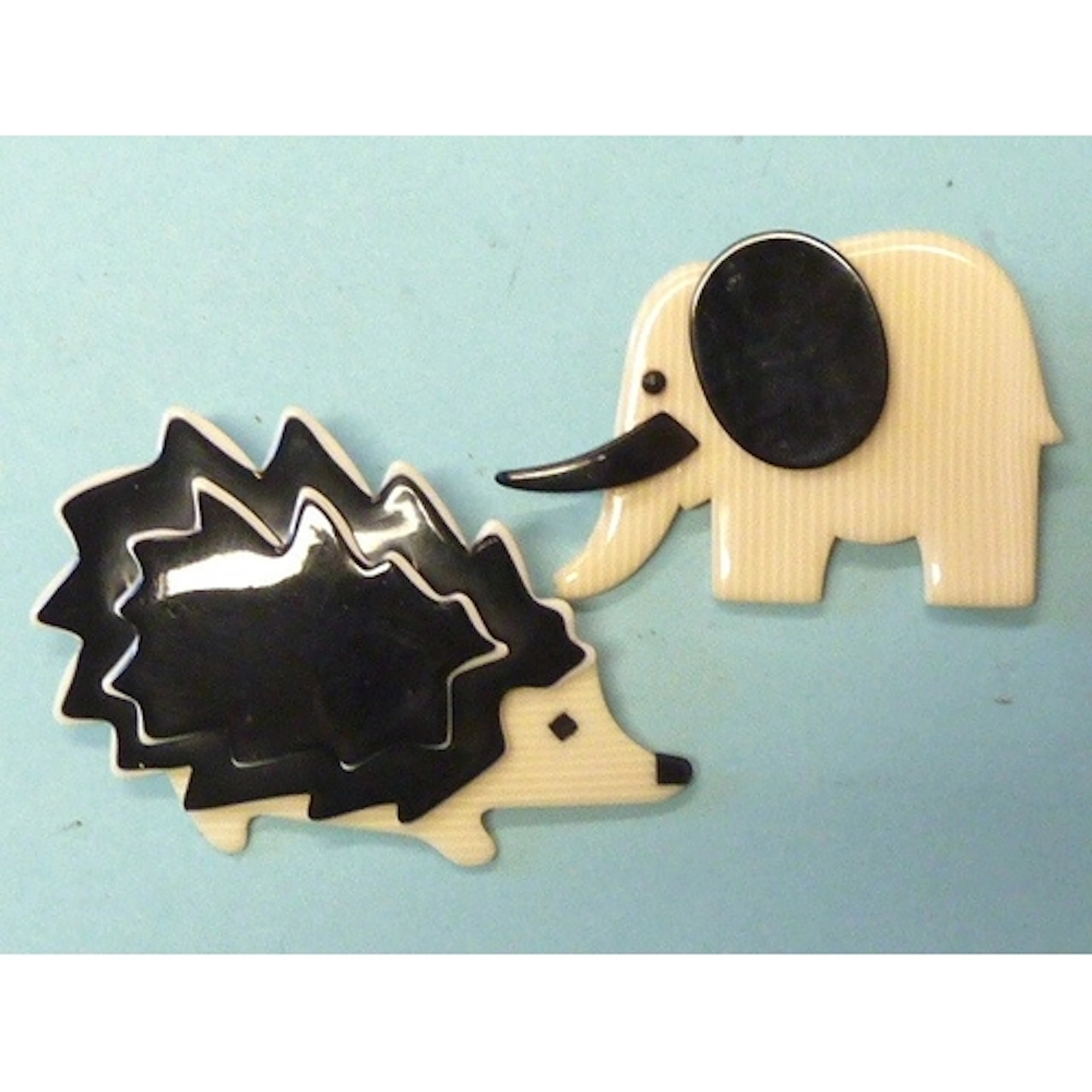 A Lea Stein elephant brooch (trunk down), ivory and black, 4...