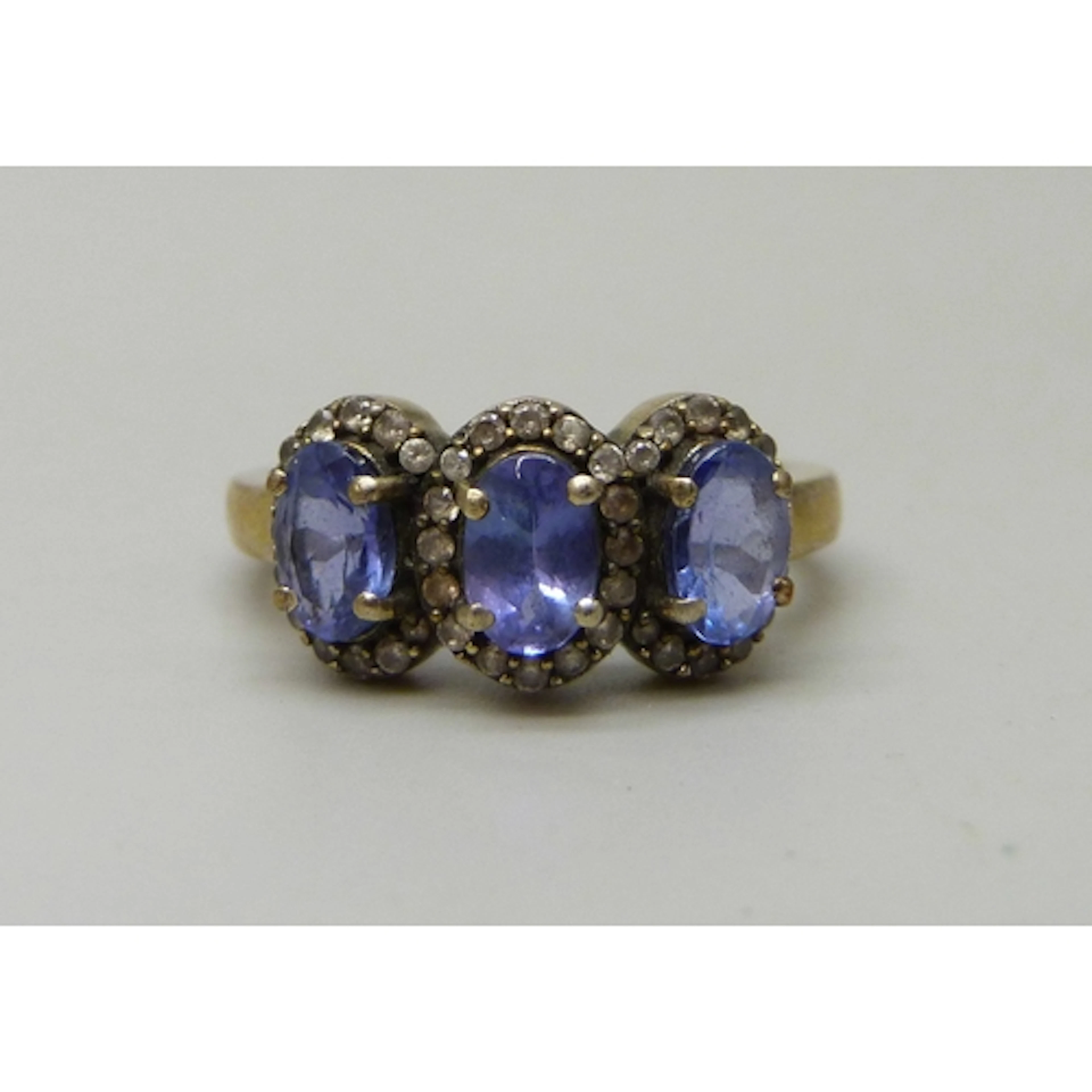 A silver iolite and white stone triple cluster ring, L, plat...