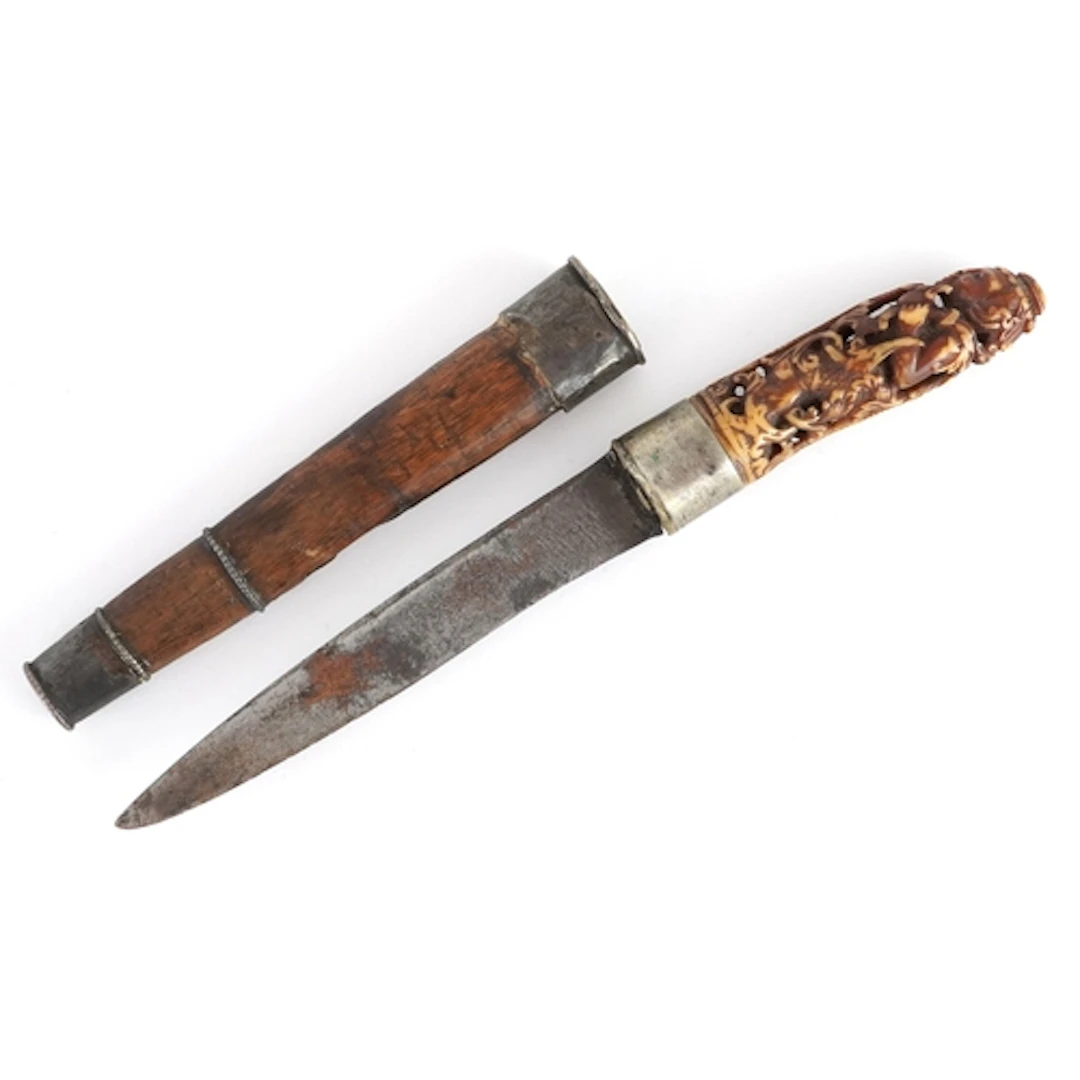 Antique Eastern hunting knife with sheath having a carved bo...