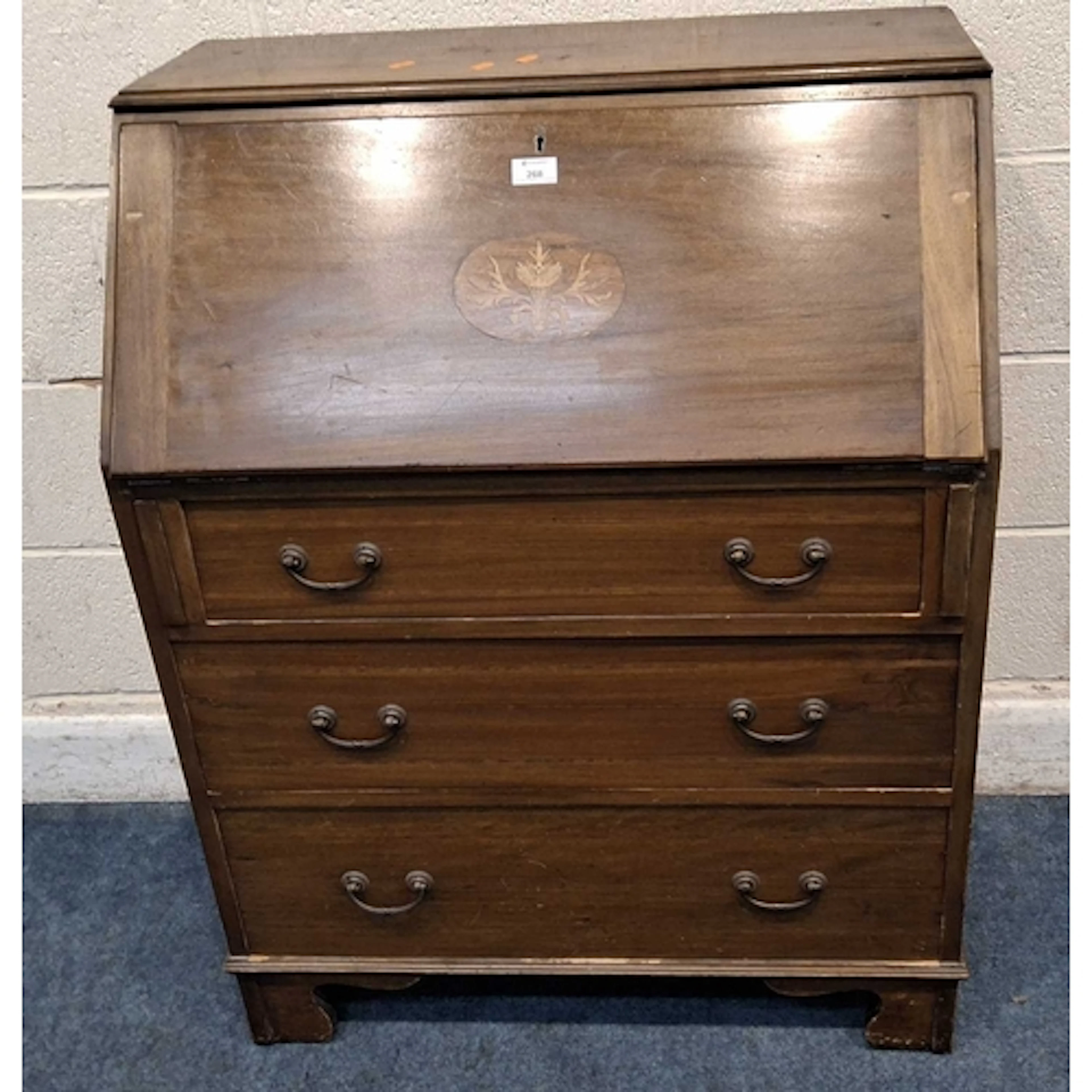 A REPRODUCTION MAHOGANY BUREAU, the fall front door enclosin...