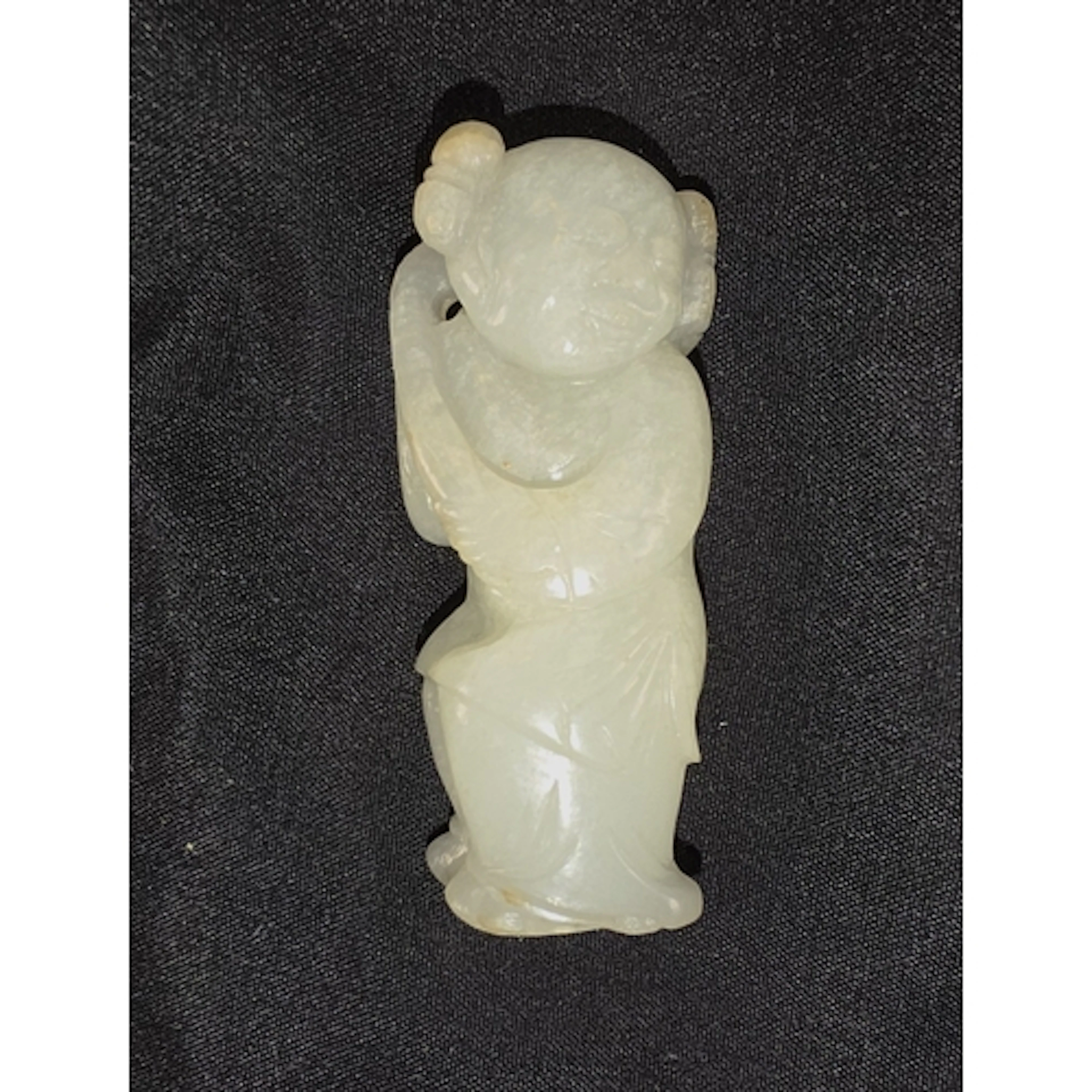 A Chinese Qing period Jade carving of boy holding flower, 5....