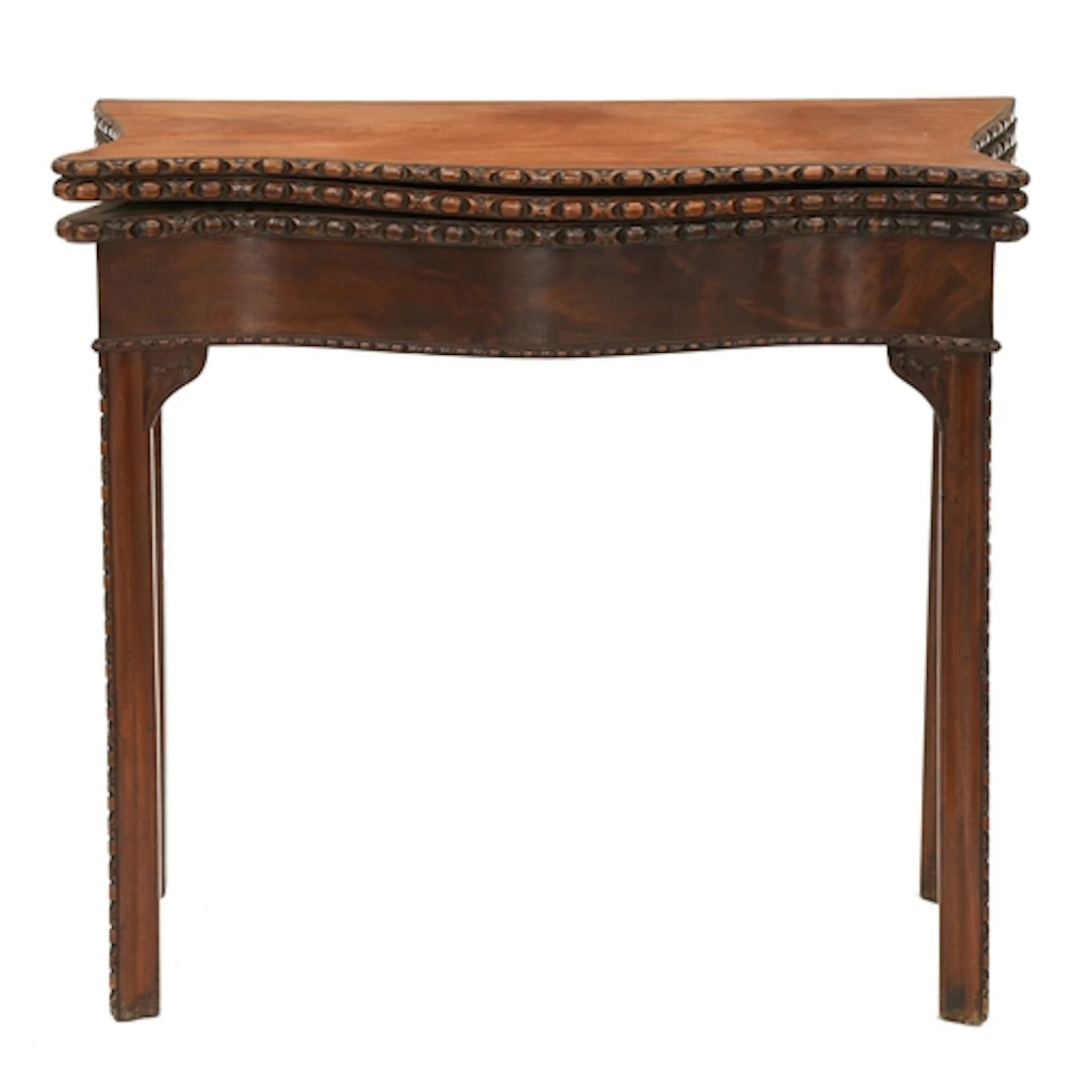 A George III three-leaf serpentine mahogany combined tea and...