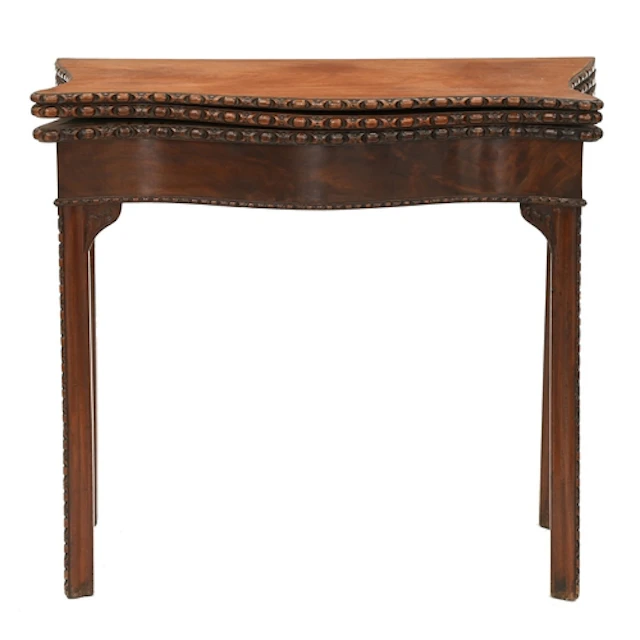 A George III three-leaf serpentine mahogany combined tea and...