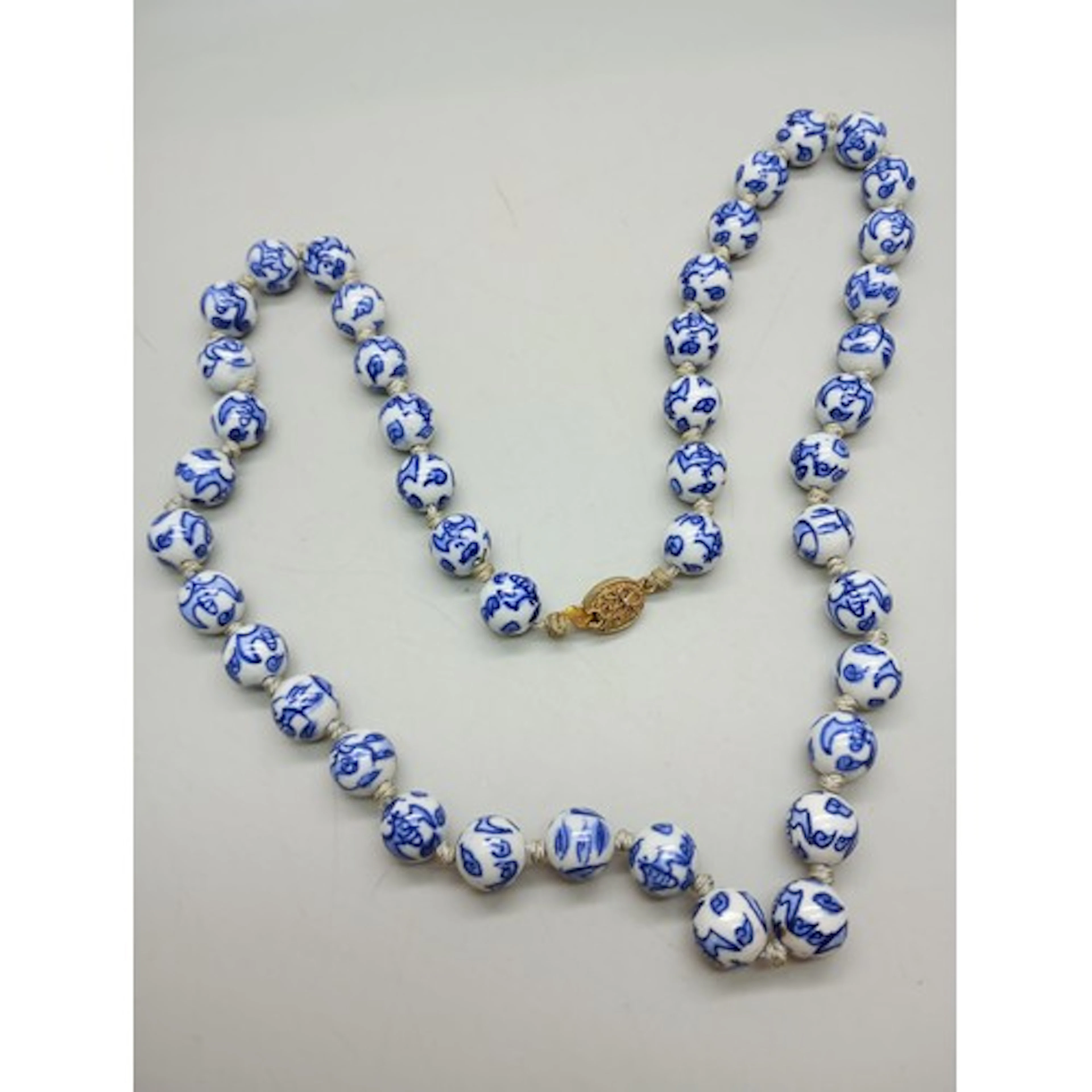 A Chinese blue and white necklace, 66cm