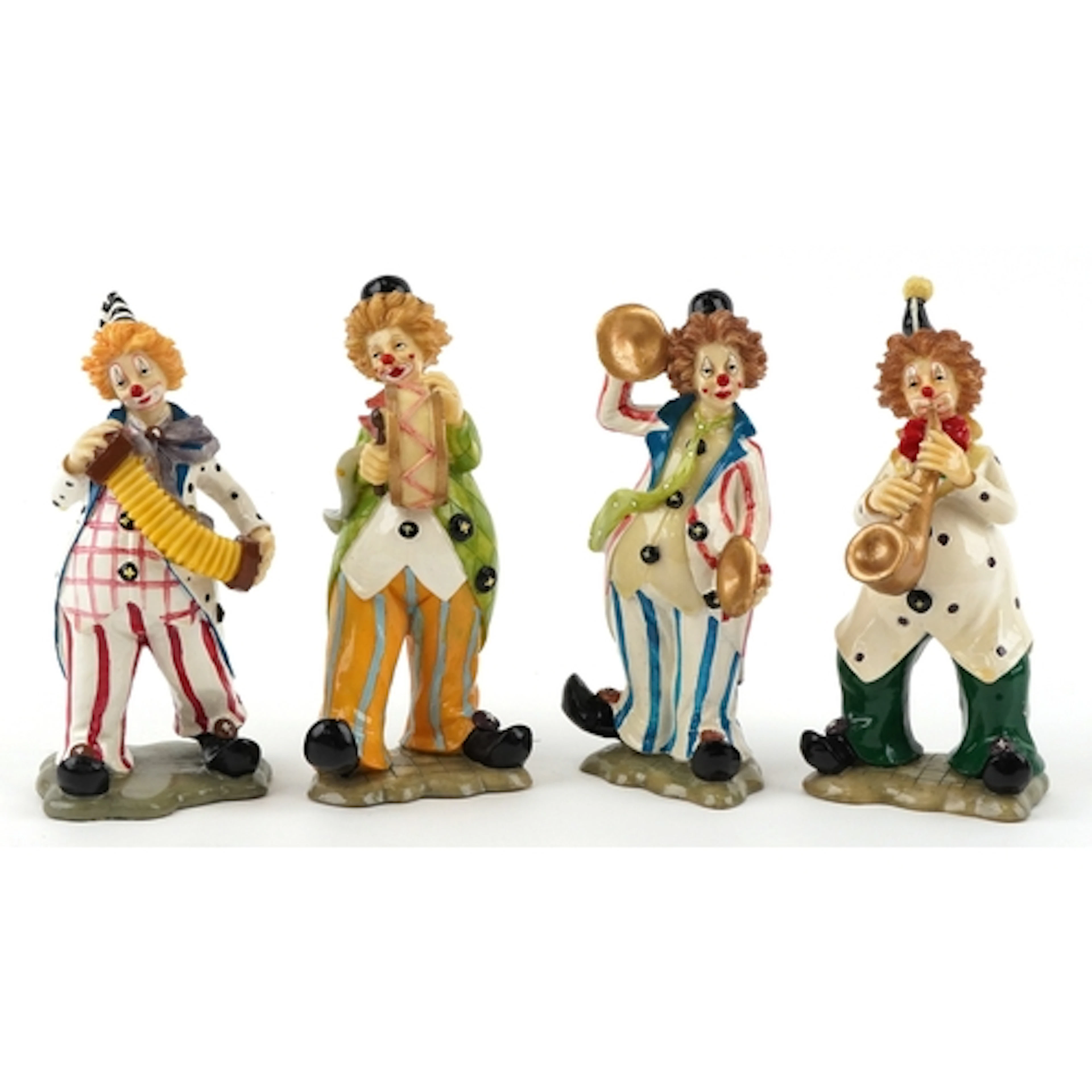 Four decorative composite model figures of clowns, 18cm high...