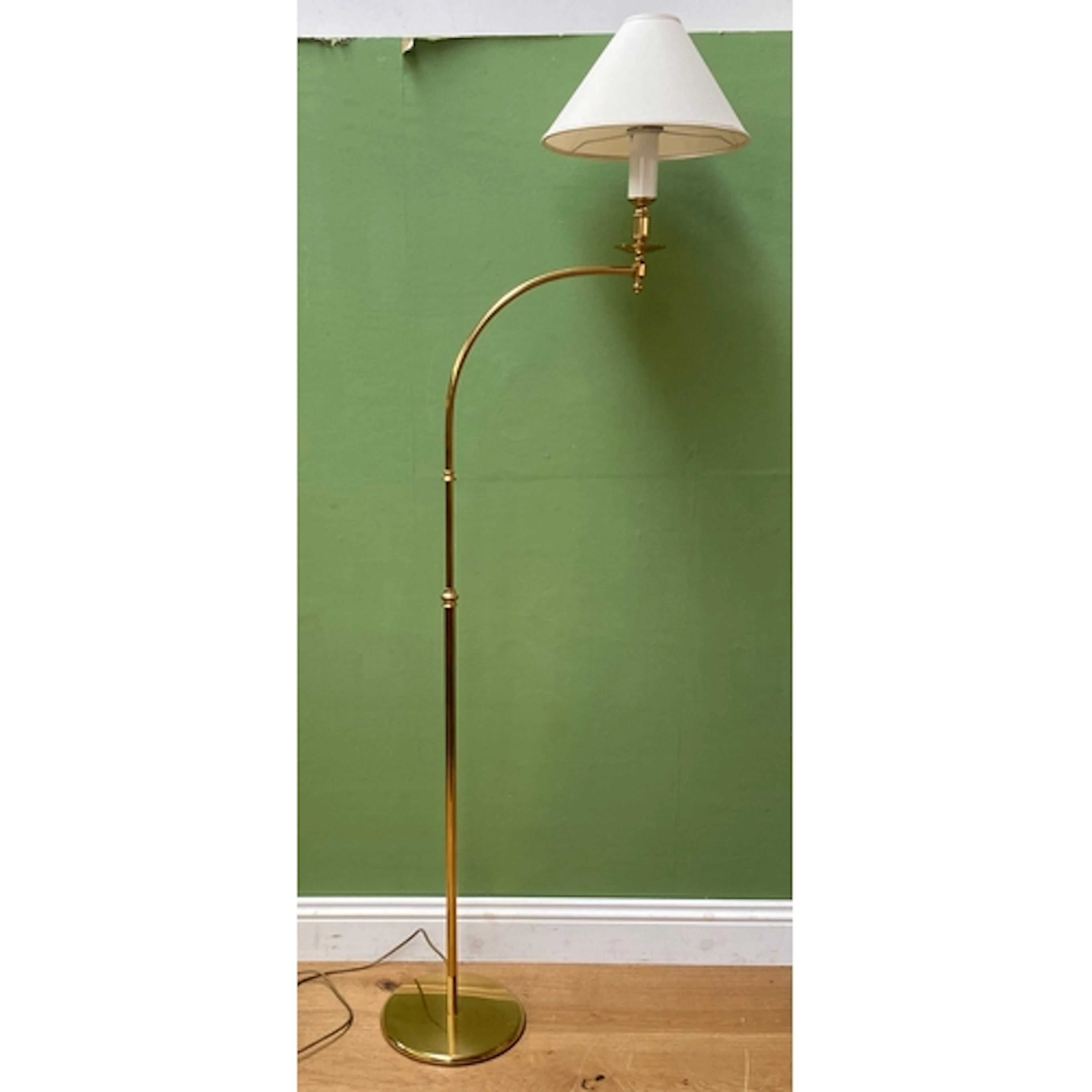 A gilt metal articulated standard lamp, together with a furt...