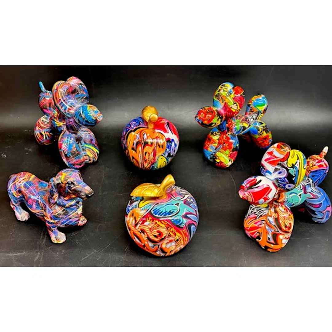 Four multi-coloured animal figures and two similar apple scu...