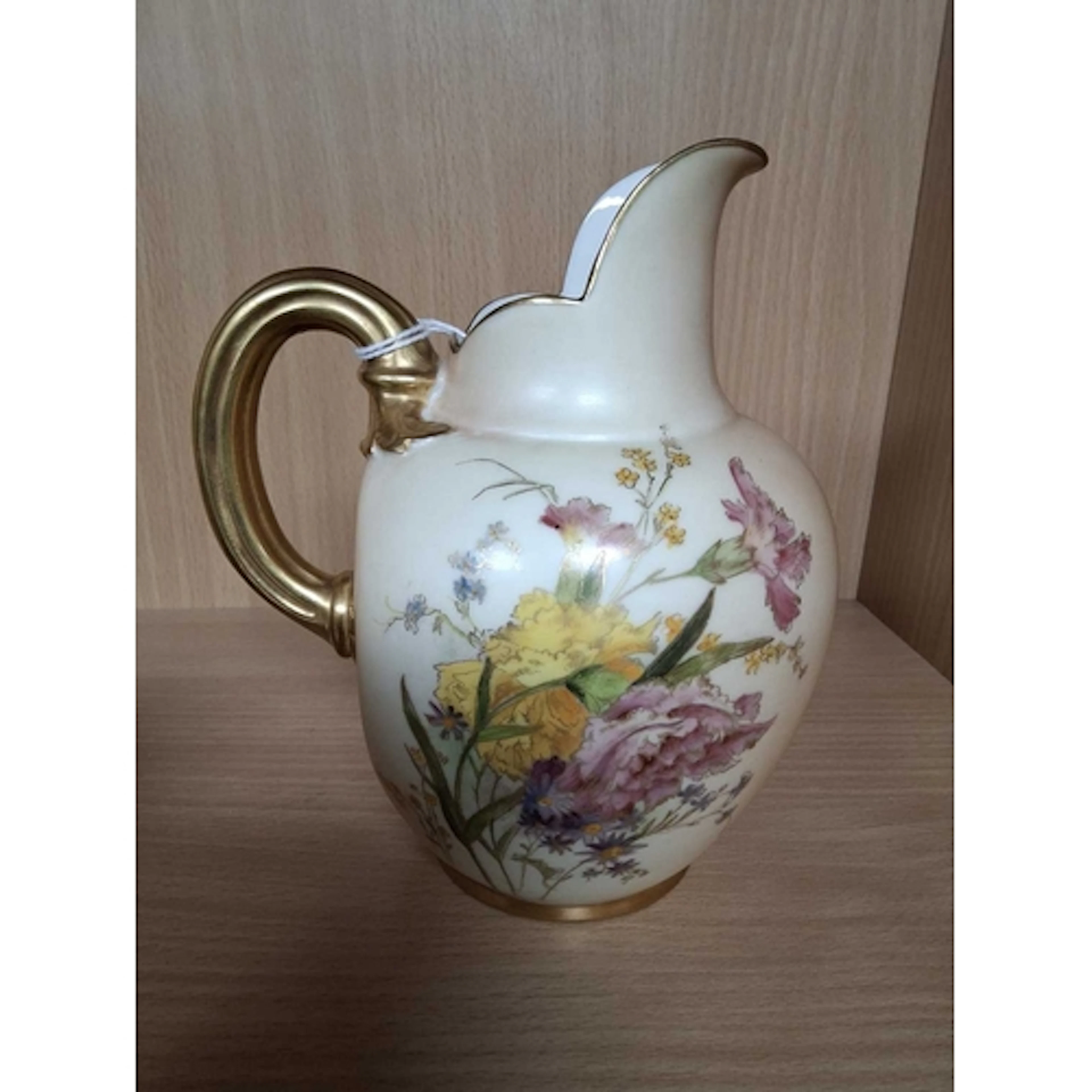 A ROYAL WORCESTER BLUSH IVORY FLAT BACK JUG, decorated with ...