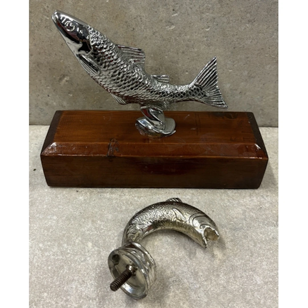 A Desmo bonnet mascot in the form of a leaping salmon on woo...