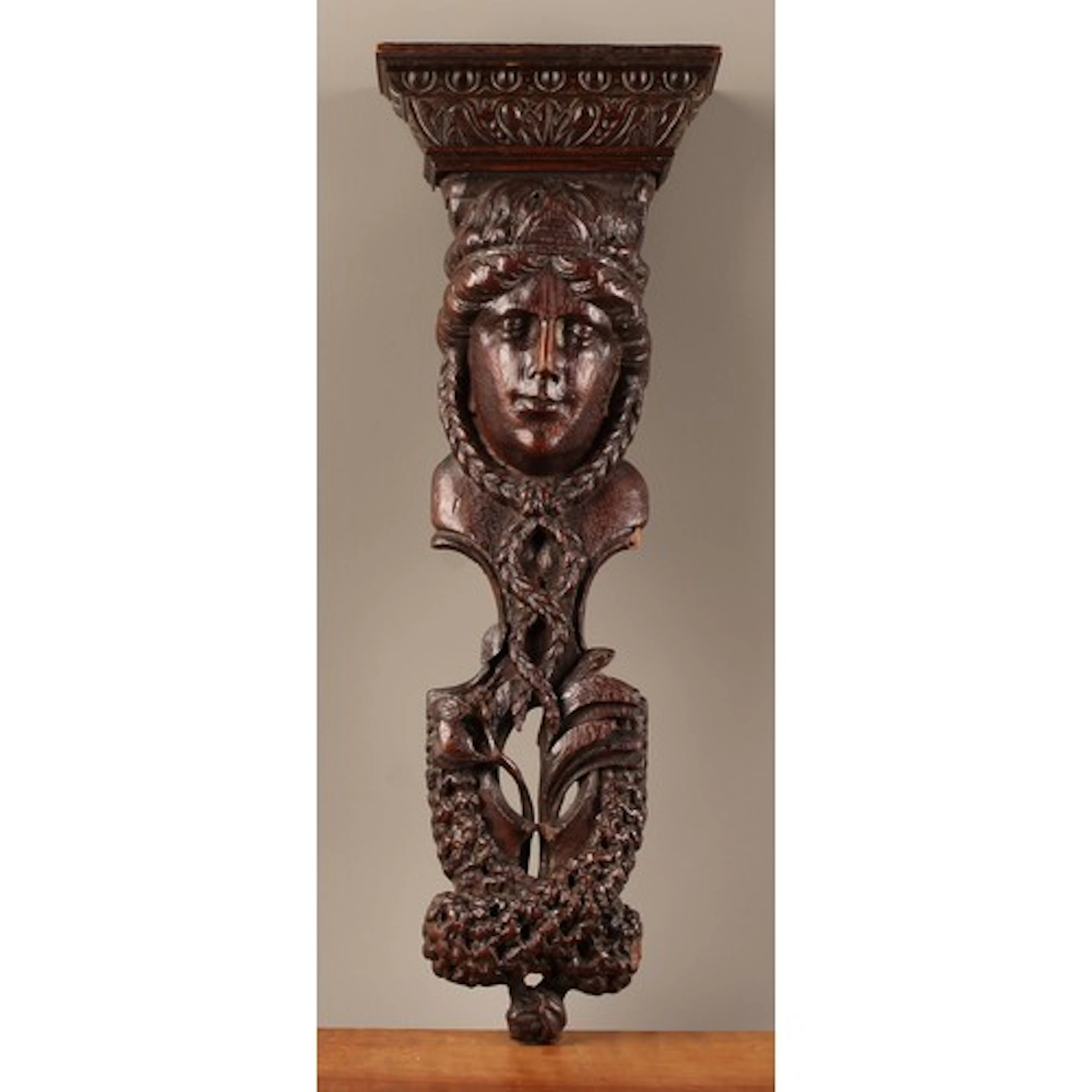 A 19th century oak wall bracket, as a term, oversailing corn...