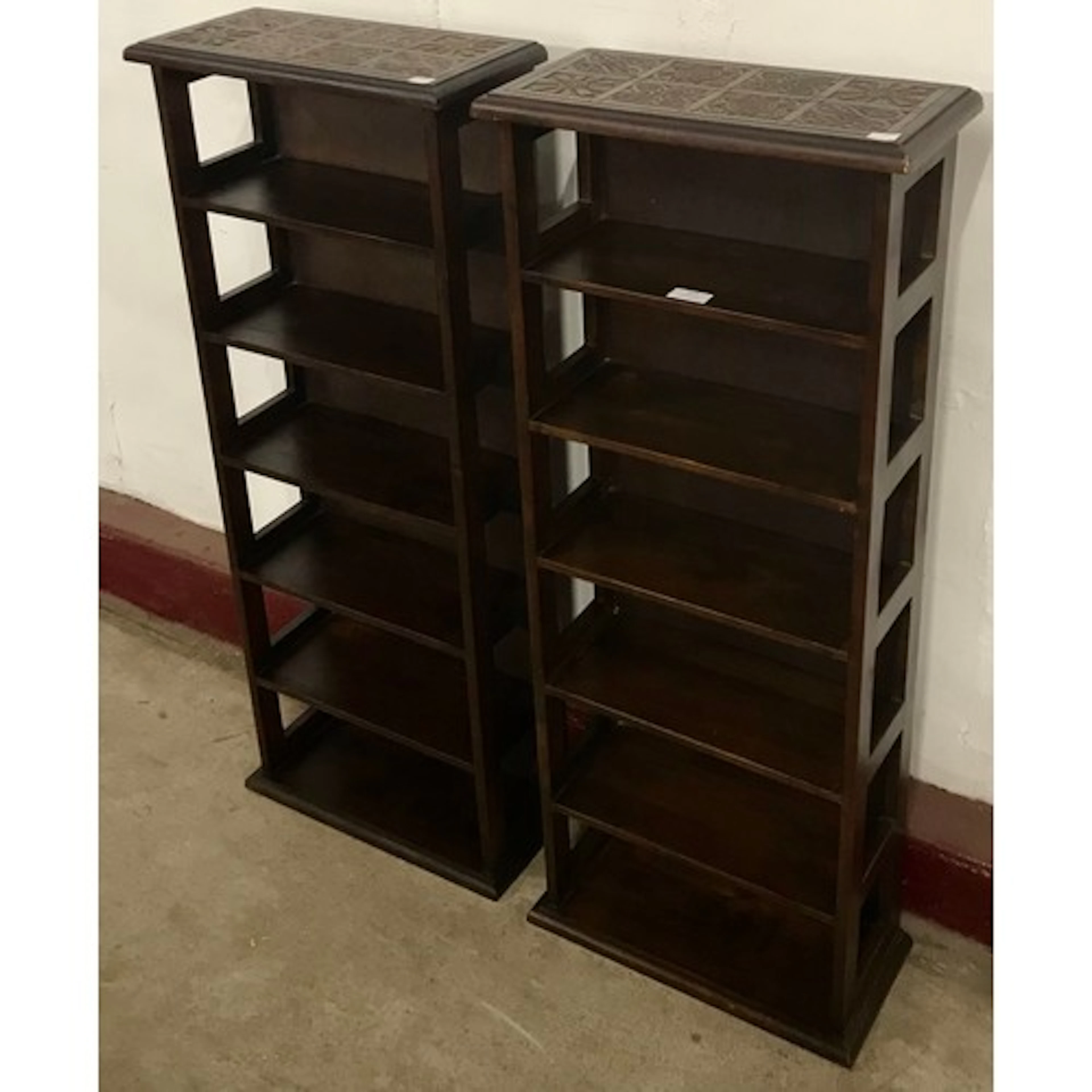 A pair of Aztec style hardwood open bookcases