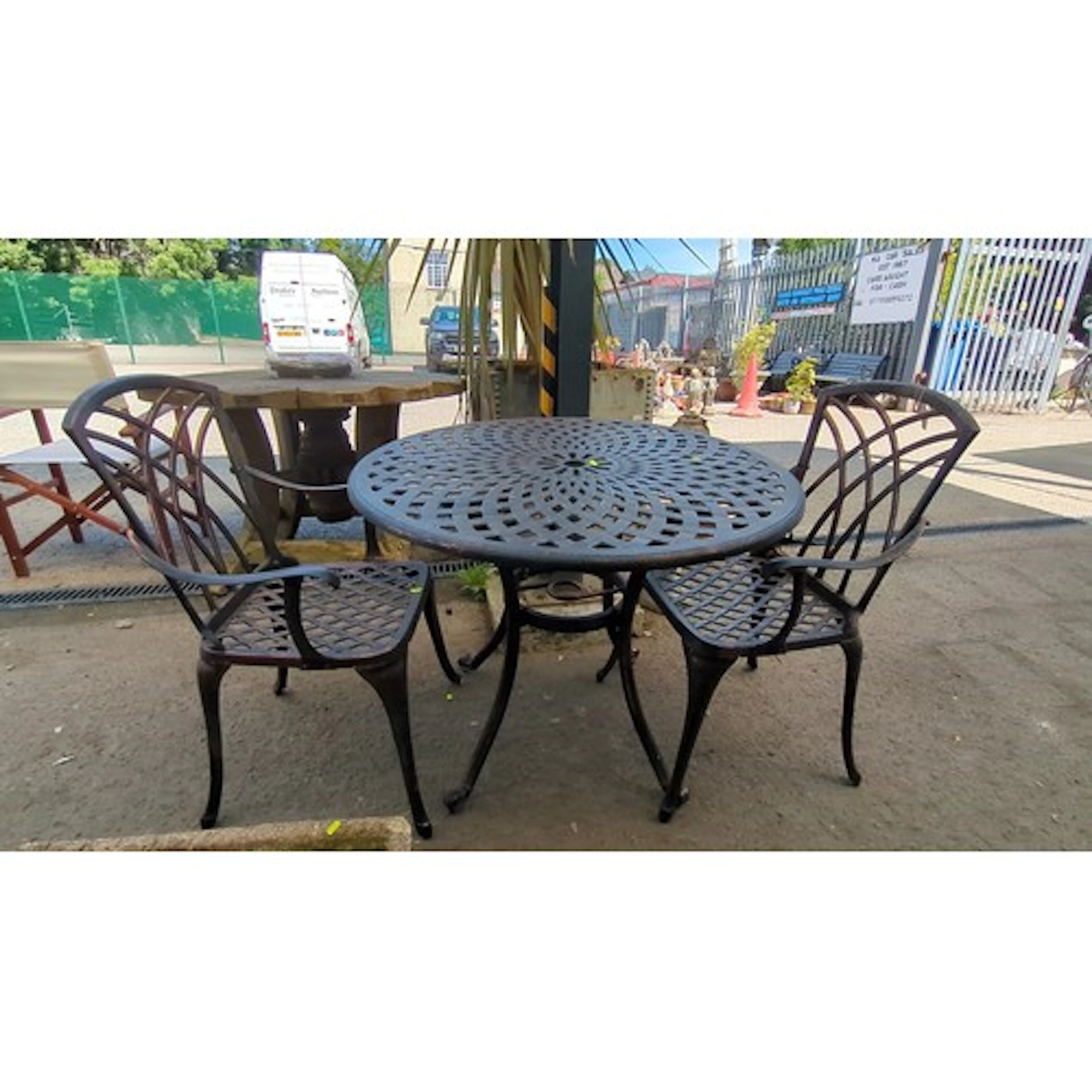 Cast metal patio bistro suite comprising a circular table wi...
