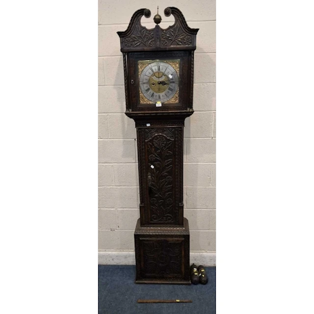 AN OAK CASED LONGCASE CLOCK, with geometric and foliate carv...