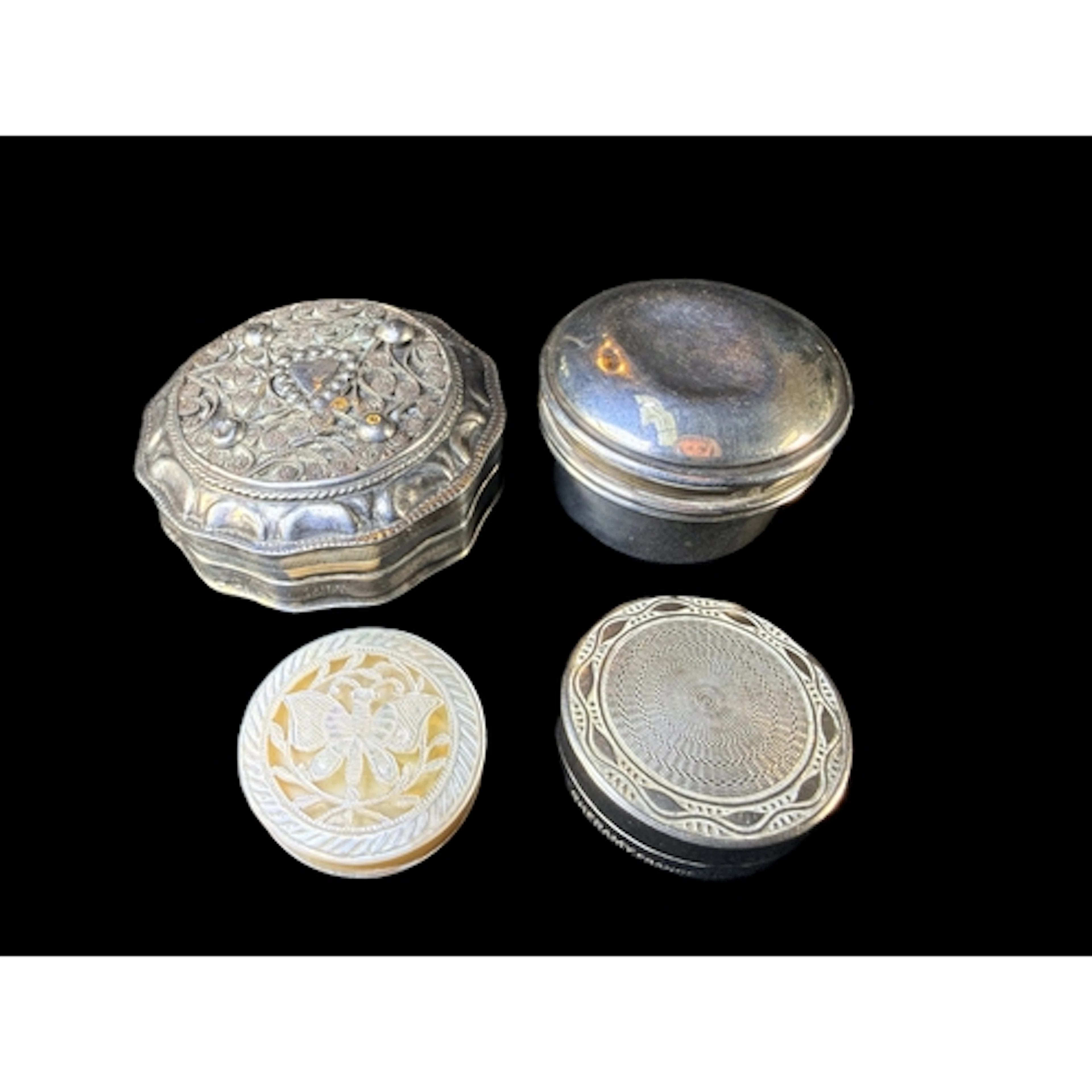 A hall marked silver pill box, a two white metal boxes, gros...