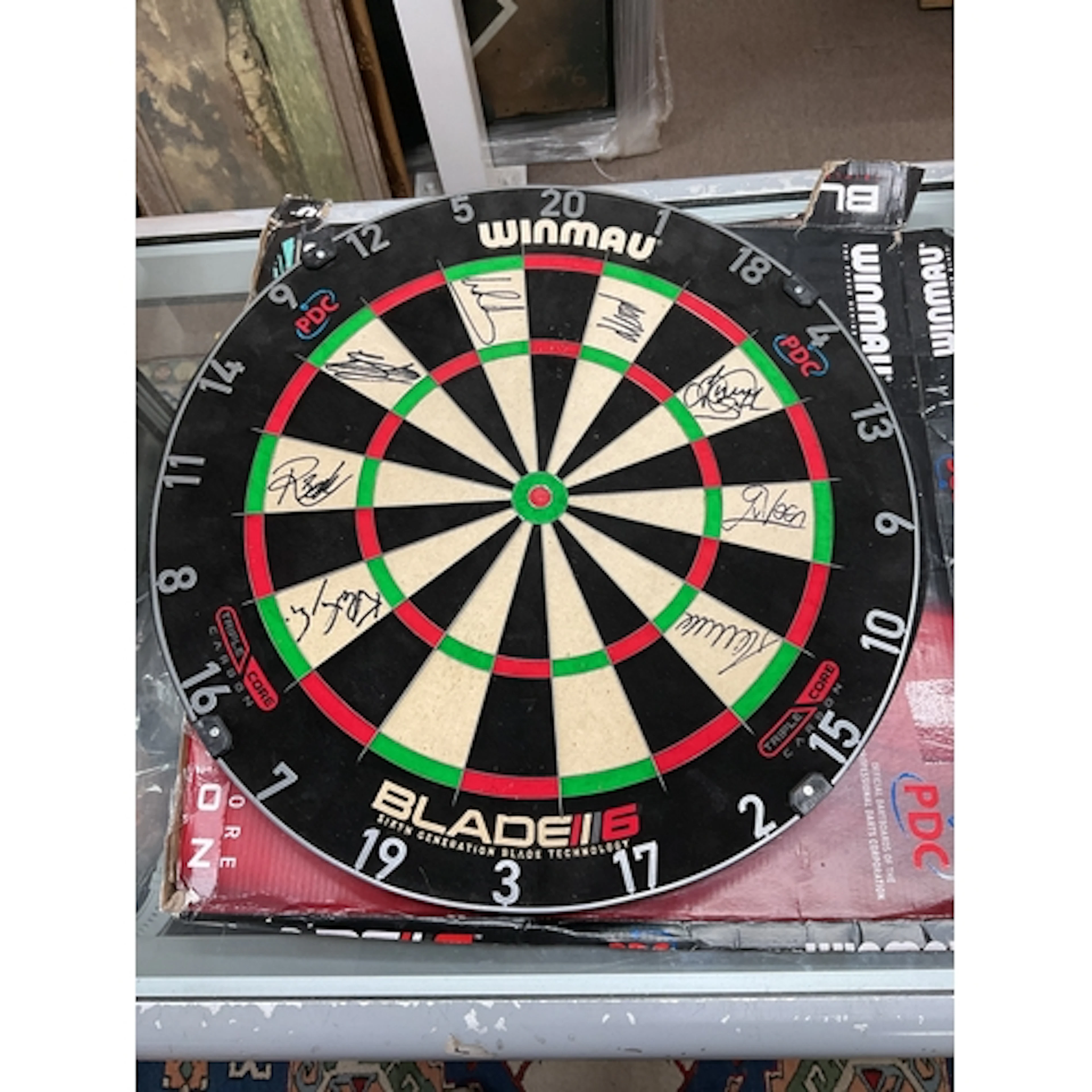 Luke Littler autographed Winmau dartboard along with other B...