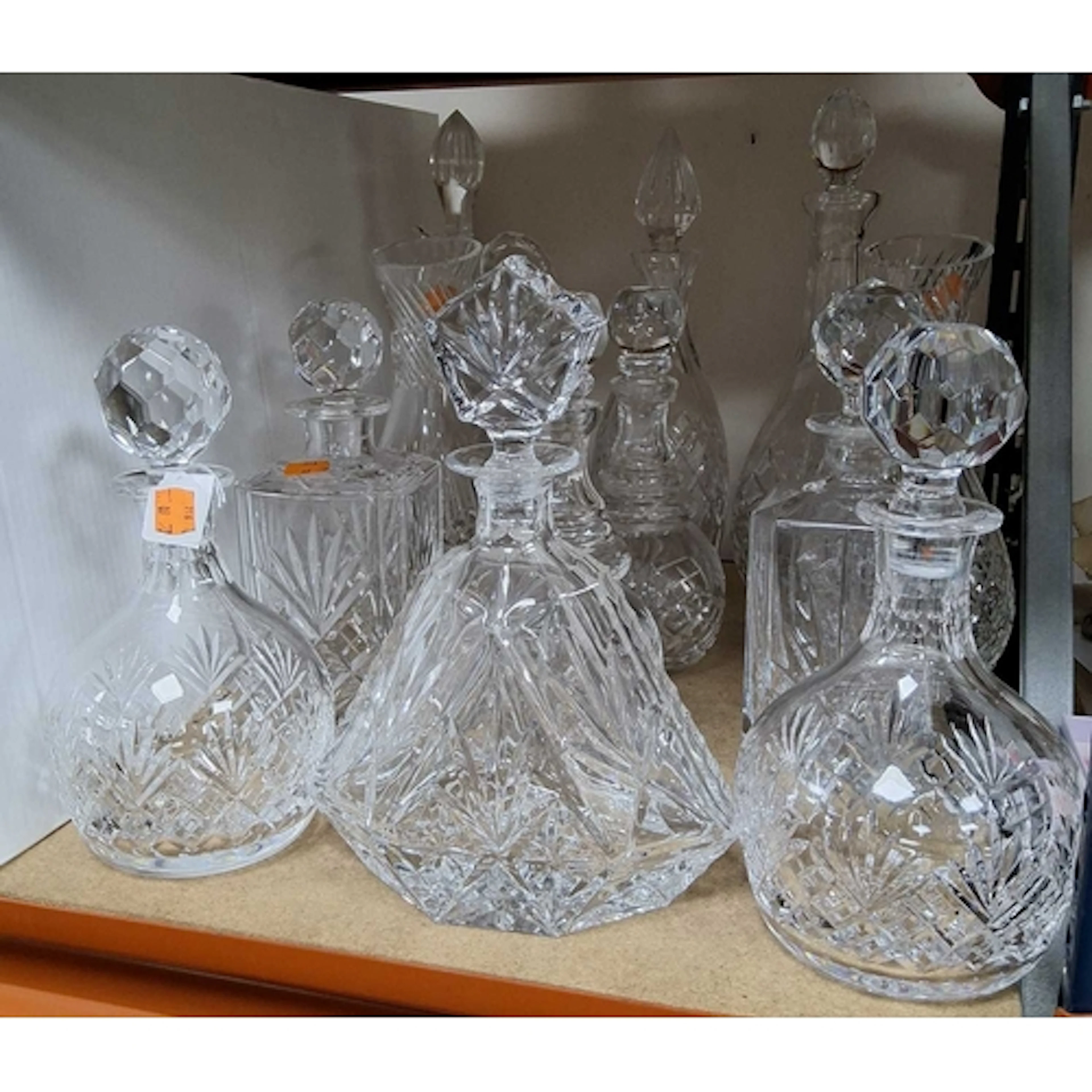 A QUANTITY OF CUT GLASS DECANTERS, comprising a selection of...