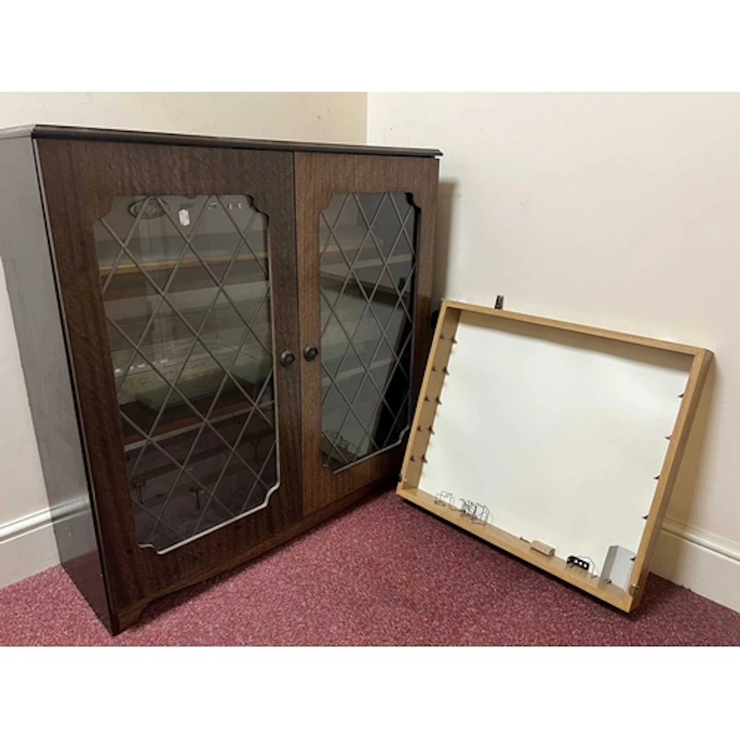 A GLASS FRONT WOODEN DISPLAY CABINET, previously used to dis...