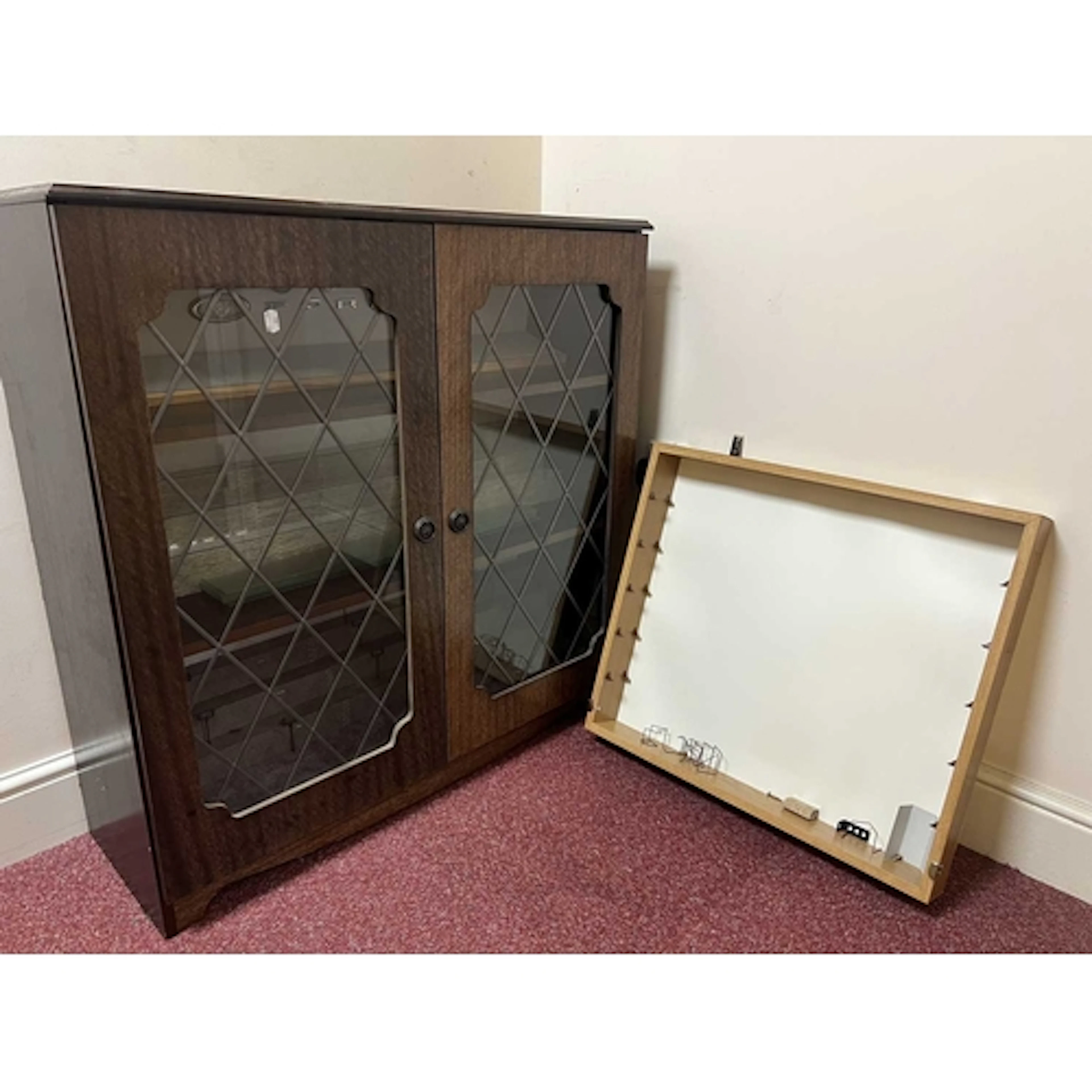 A GLASS FRONT WOODEN DISPLAY CABINET, previously used to dis...