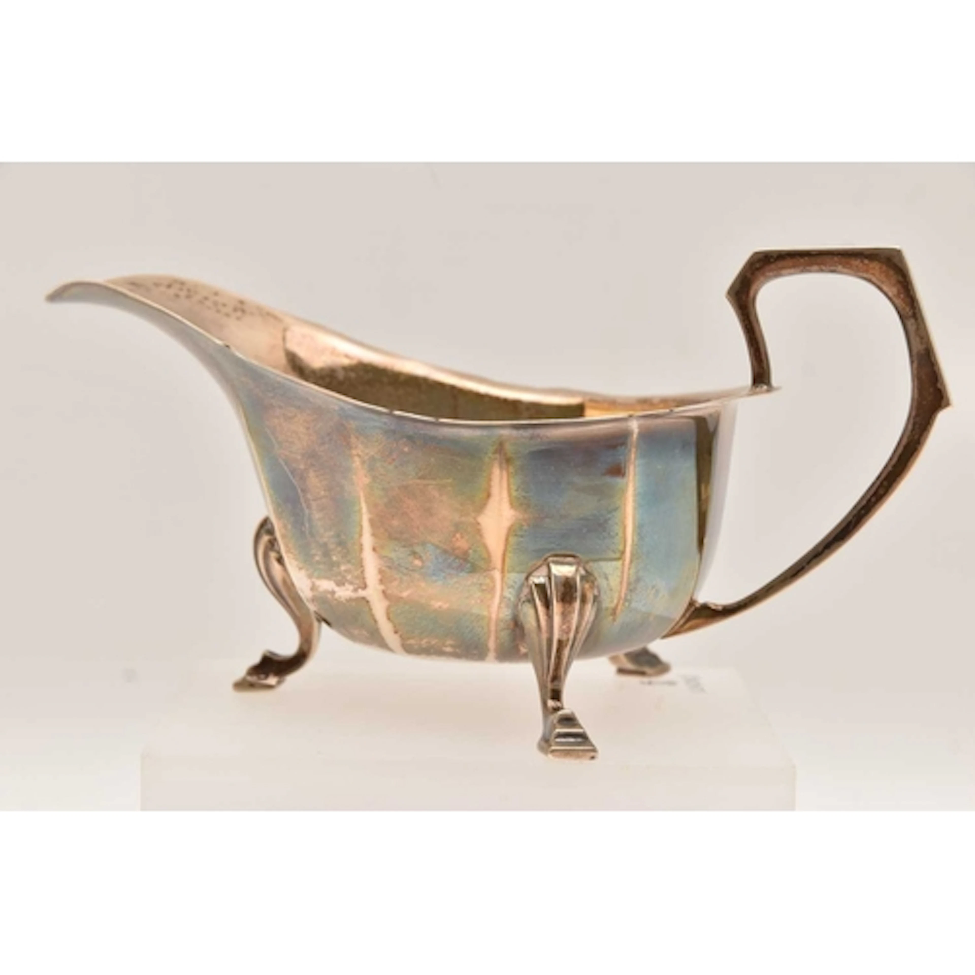 A GEORGE VI SILVER SAUCE BOAT, faceted form with wavy rim an...