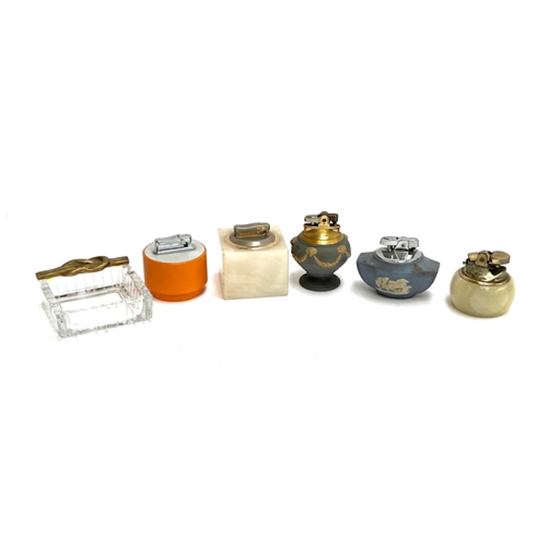 A small lot of table lighters to include two Wedgwood Jasper...