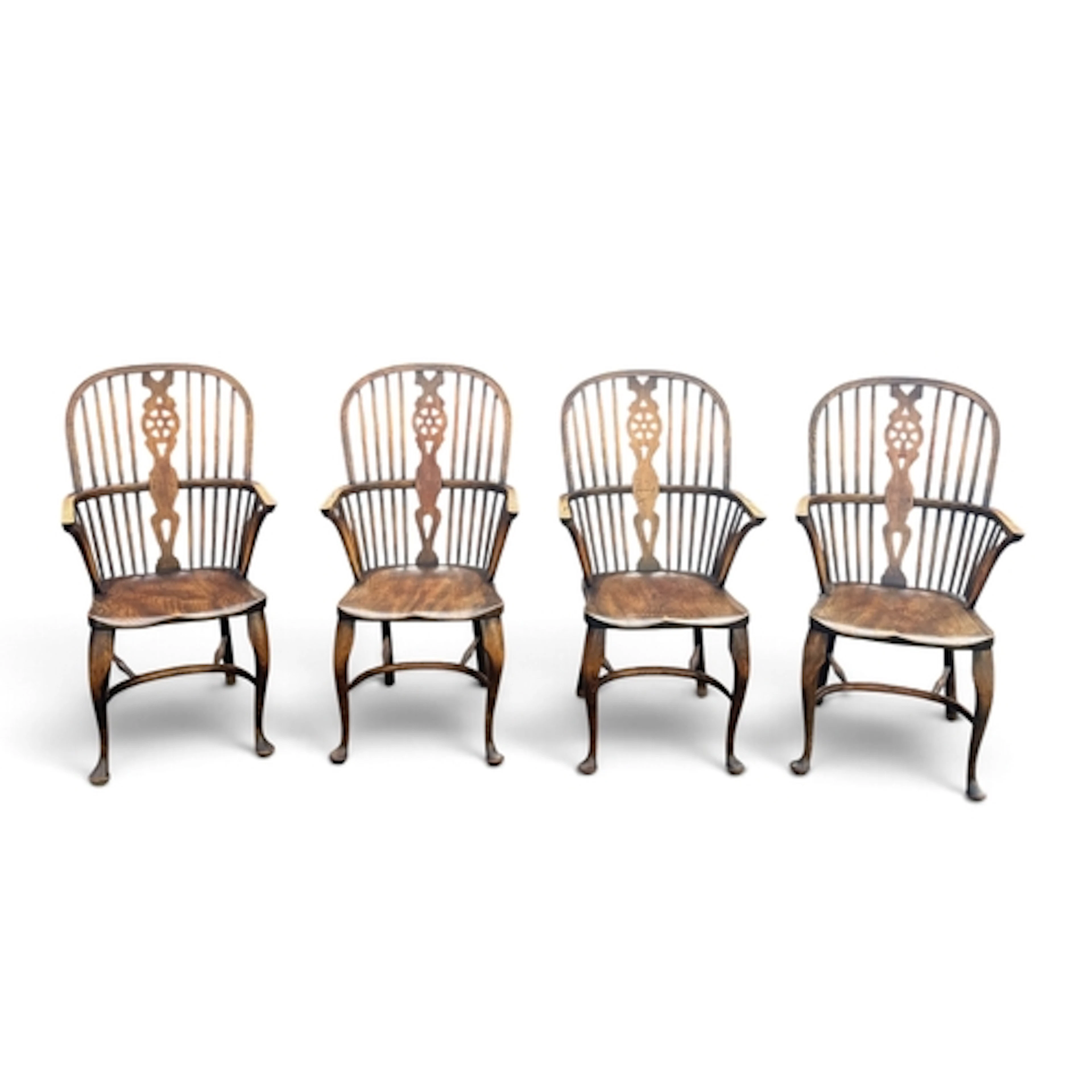 A SET OF FOUR REPRODUCTION BEECH AND ELM WINDSOR ELBOW CHAIR...