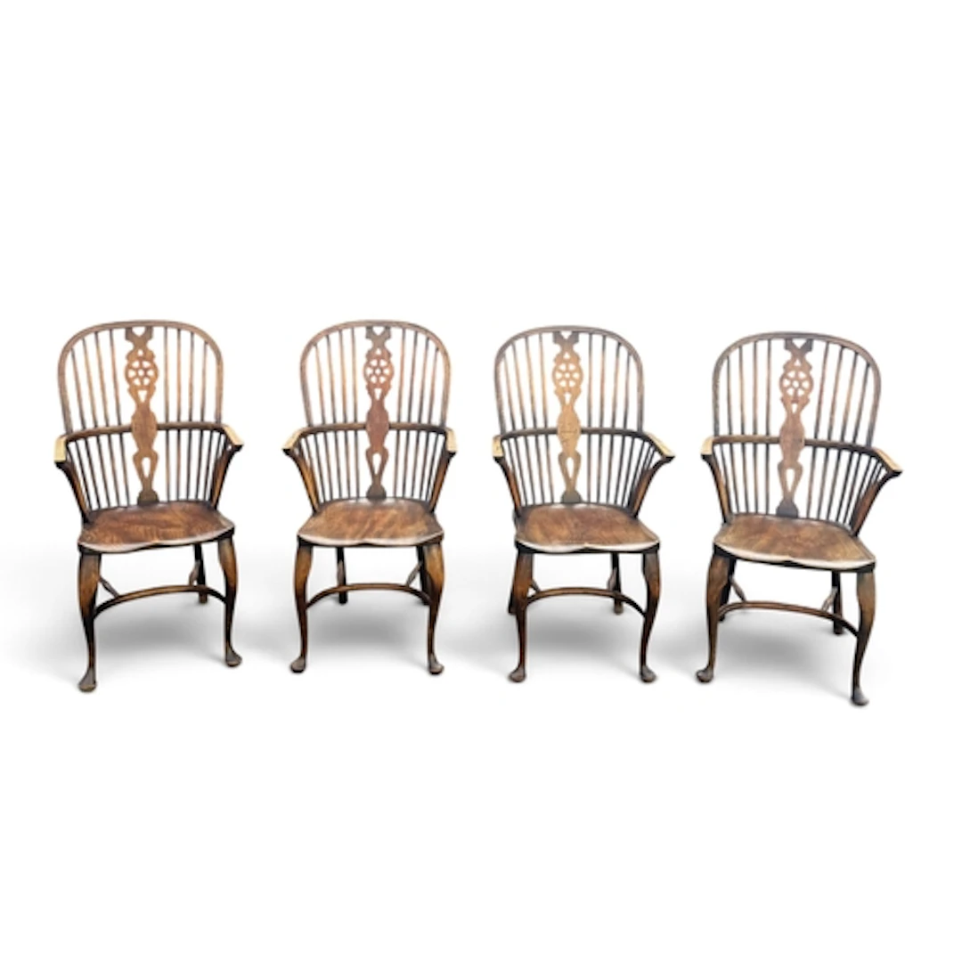 A SET OF FOUR REPRODUCTION BEECH AND ELM WINDSOR ELBOW CHAIR...