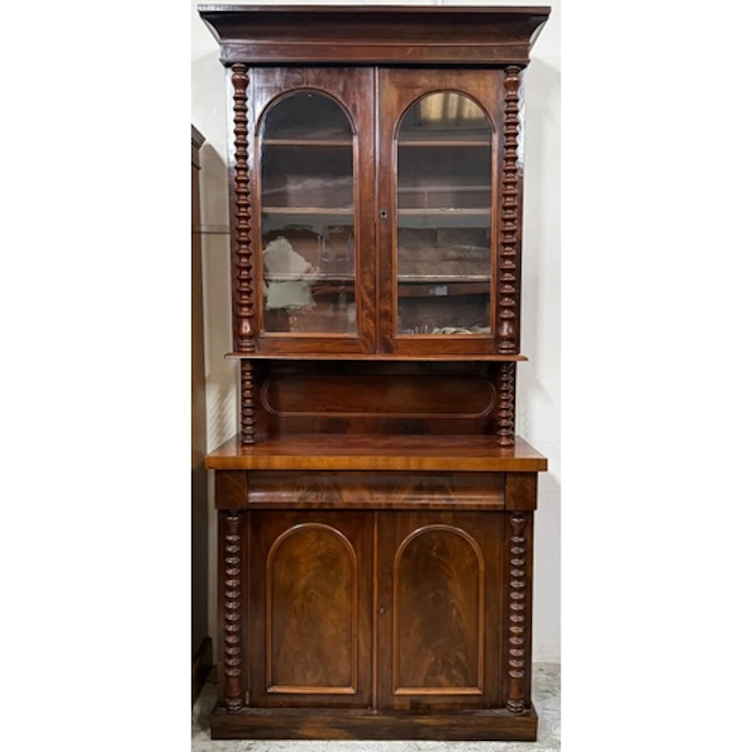 A mahogany two tier step-back library bookcase with arch gla...