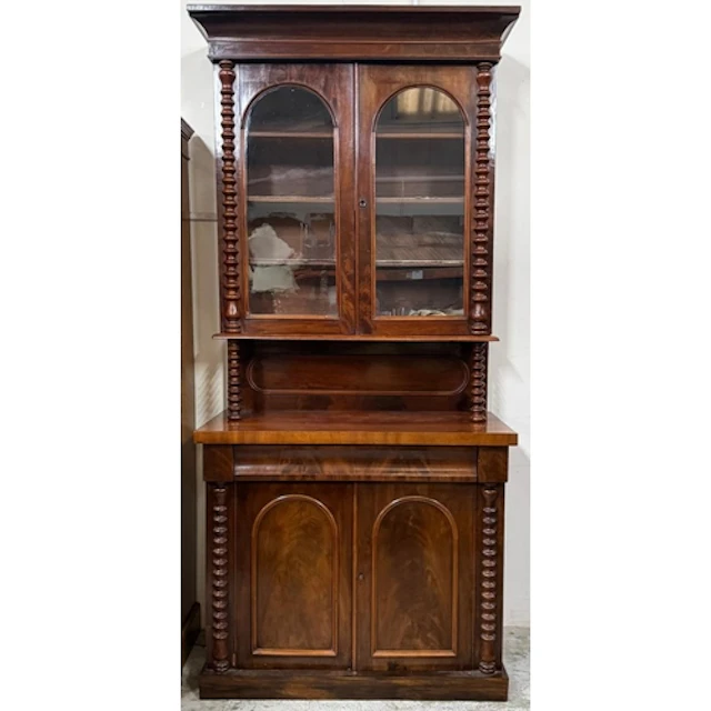 A mahogany two tier step-back library bookcase with arch gla...