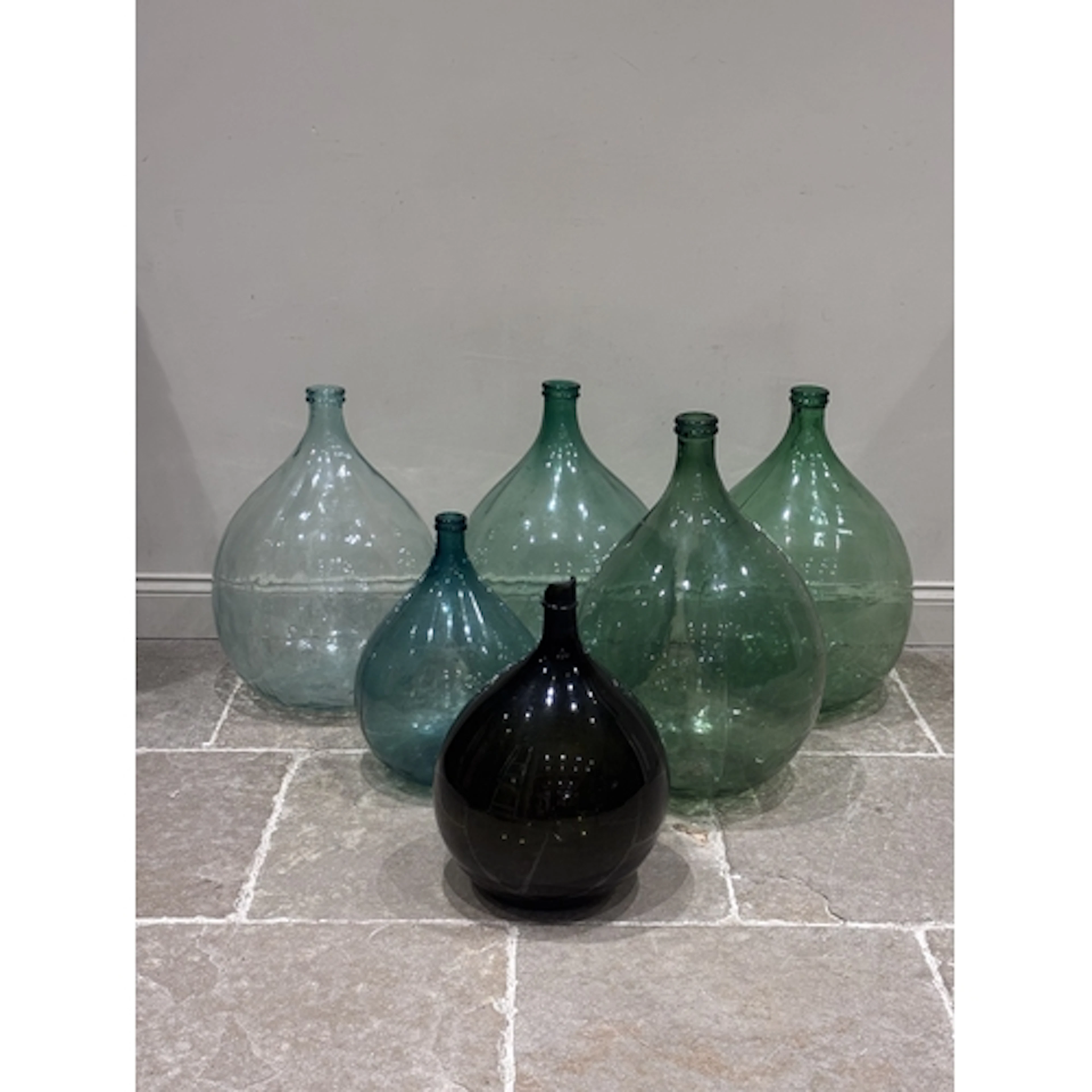 Six Italian moulded glass wine jars of large proportions, 20...