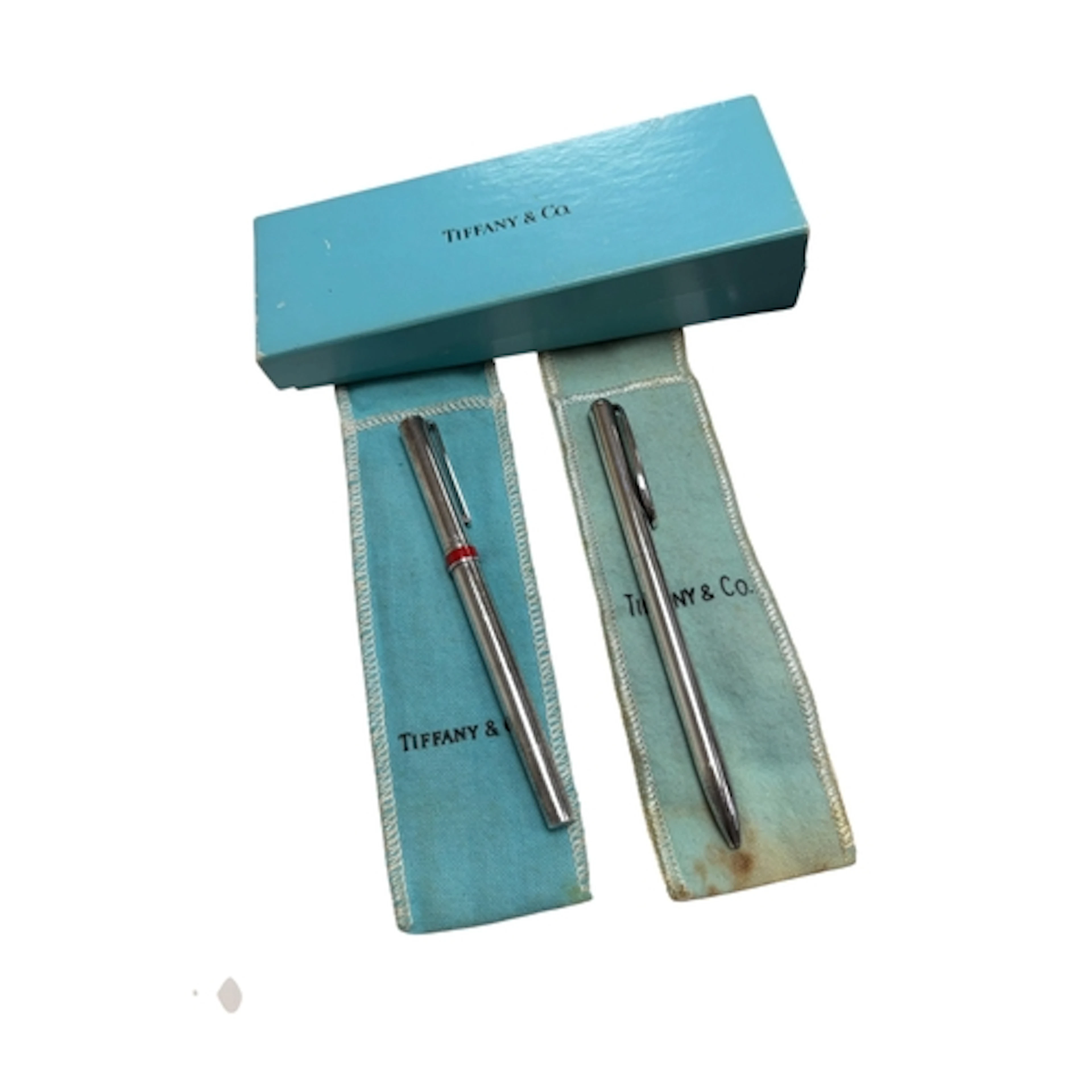 Two Tiffany and Co silver pens, one with red enamel collar, ...