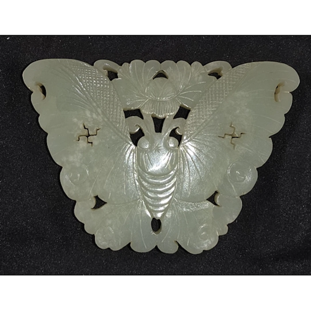 A Chinese 18th/19th century carved jade pendant of butterfly...