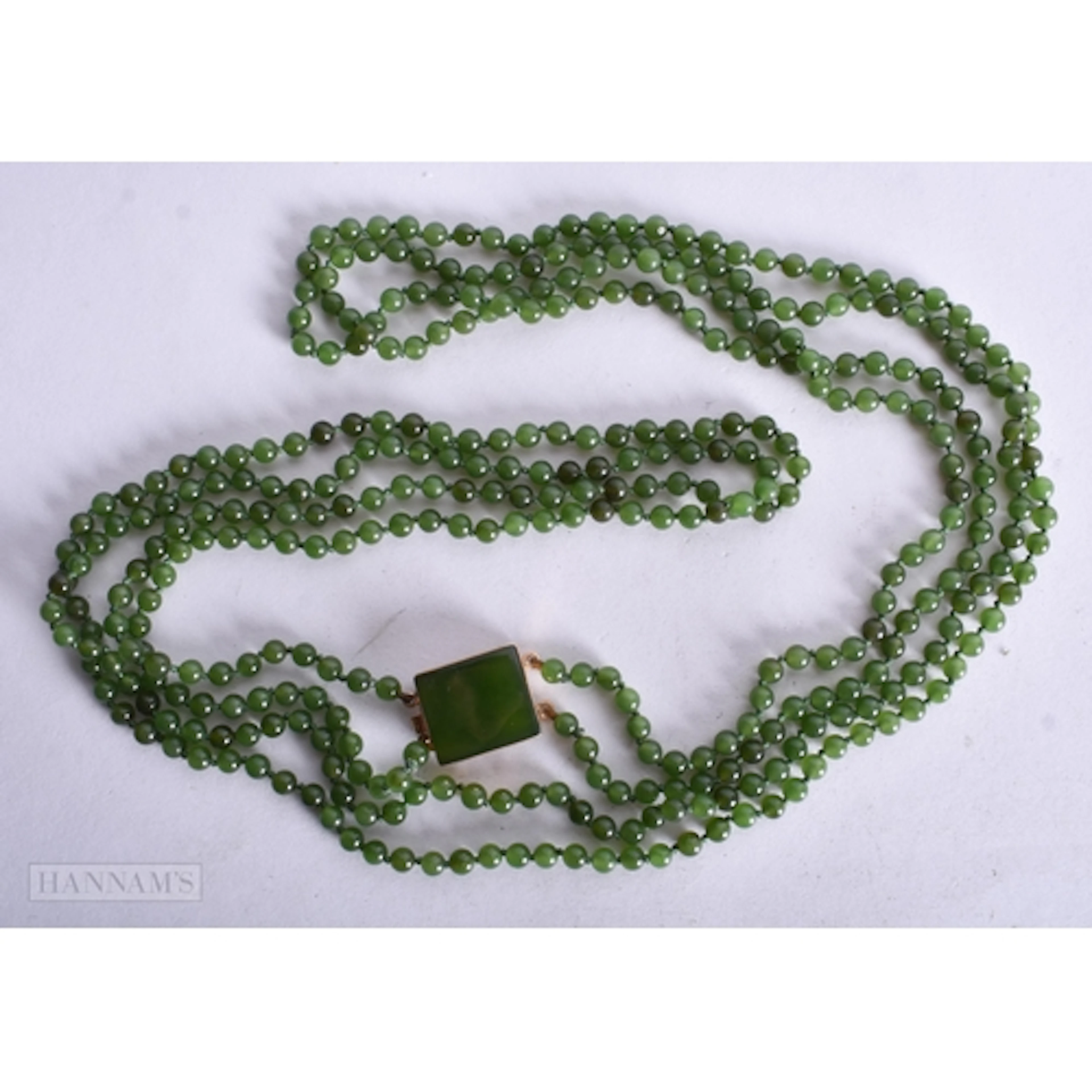 AN 18CT GOLD CHINESE JADE NECKLACE. 47.8 grams. Clasp approx...