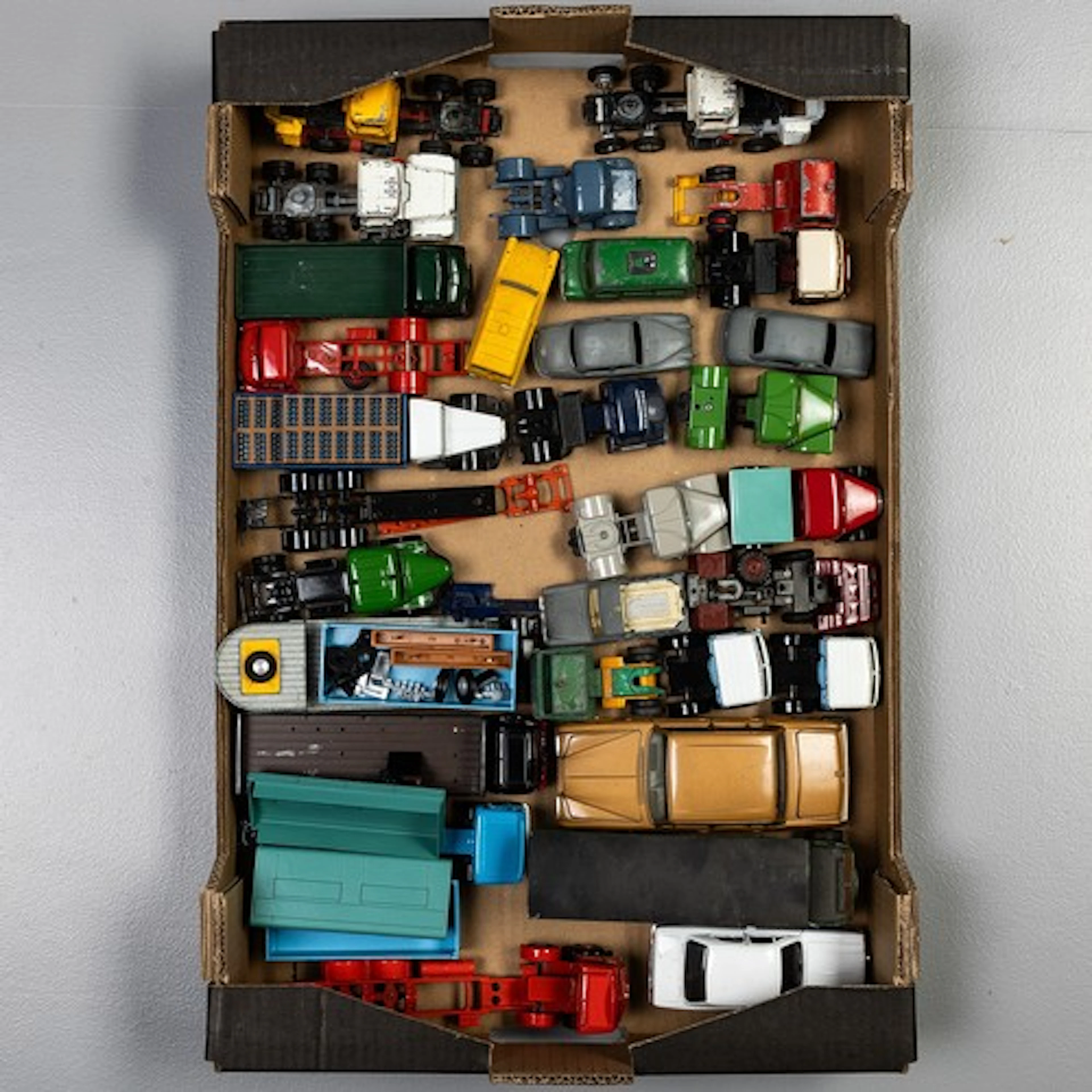 Fruit tray containing a selection of unboxed playworn Corgi ...