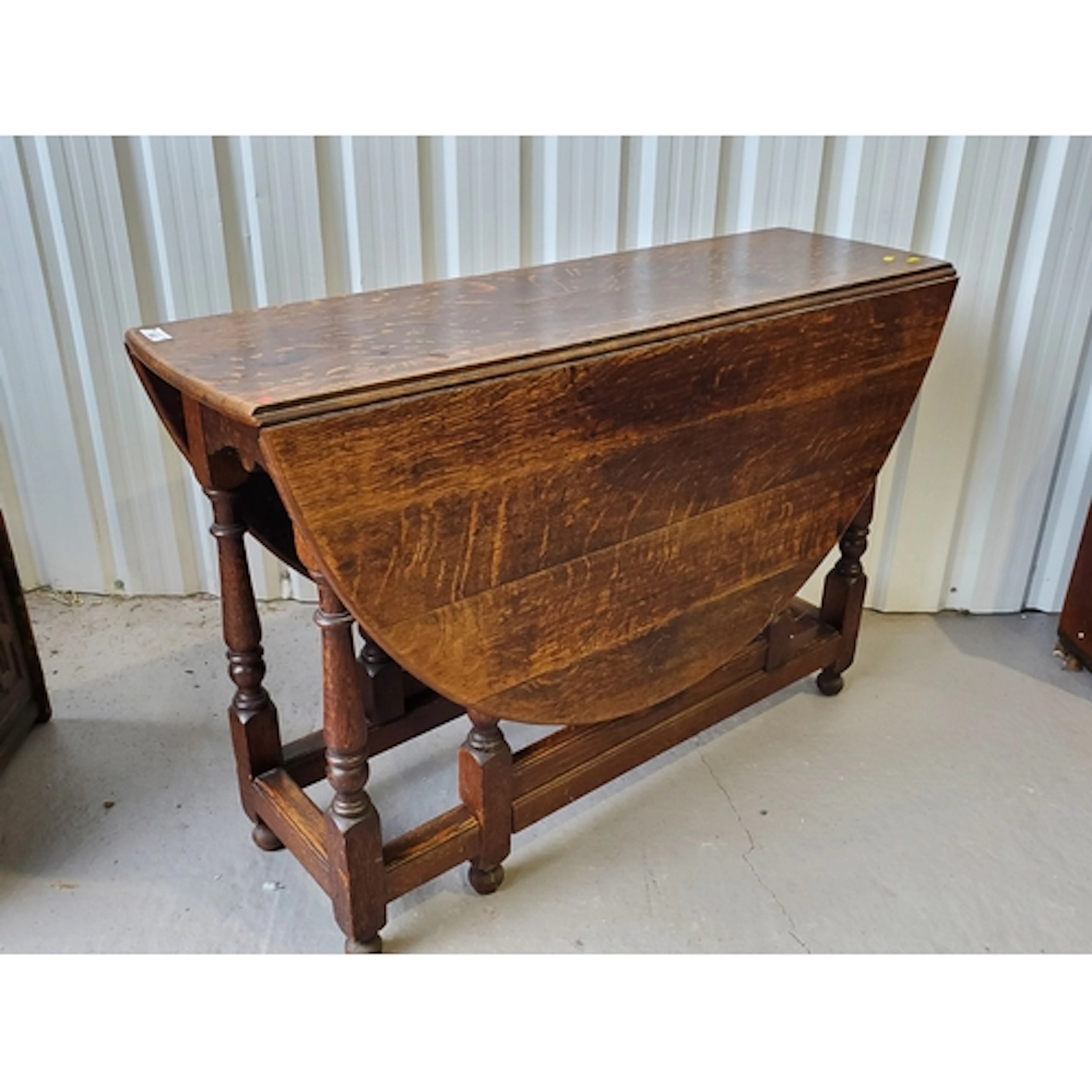 An antique oak Gateleg Table on baluster turned supports 3ft...