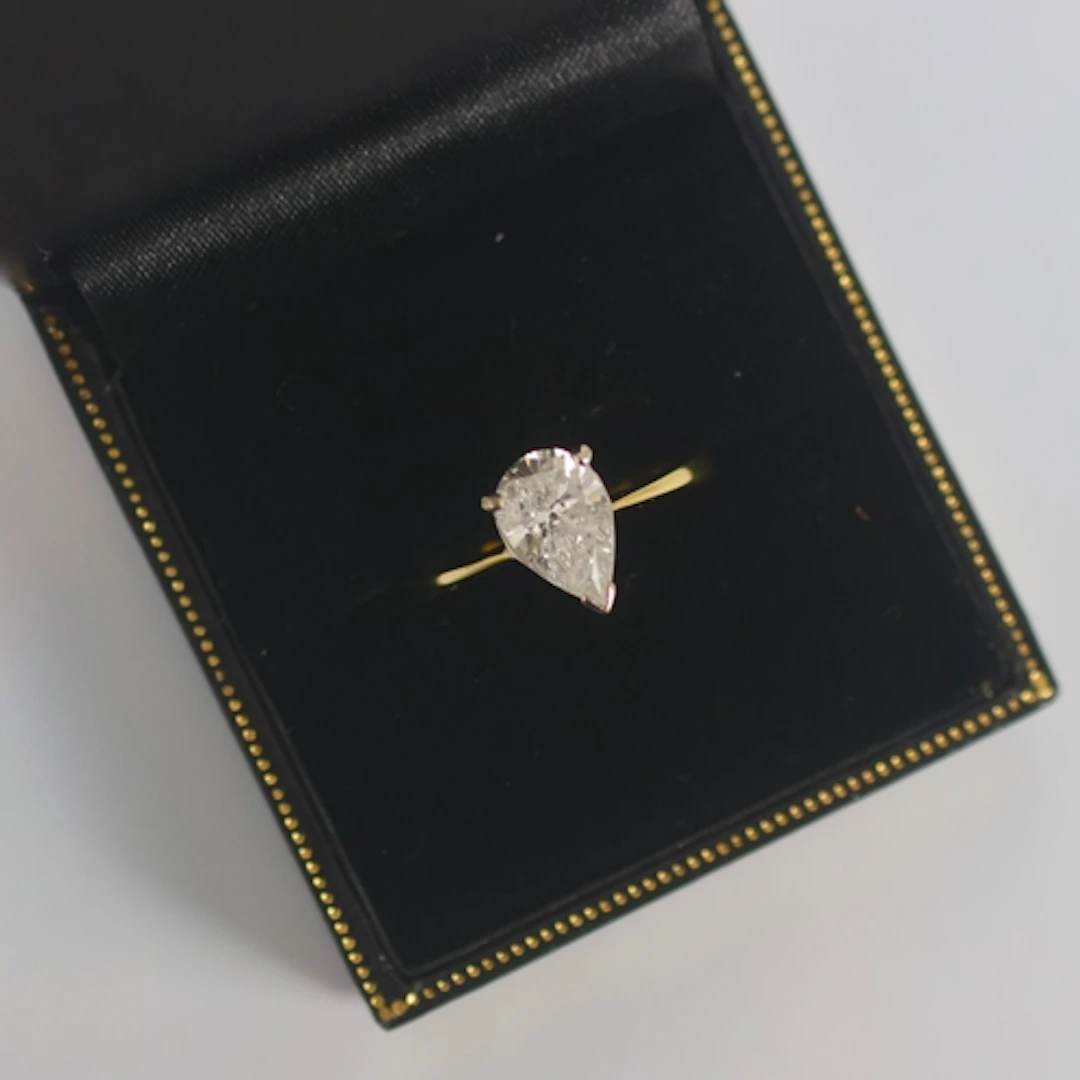 A late 20th century diamond solitaire, the pear cut diamond ...