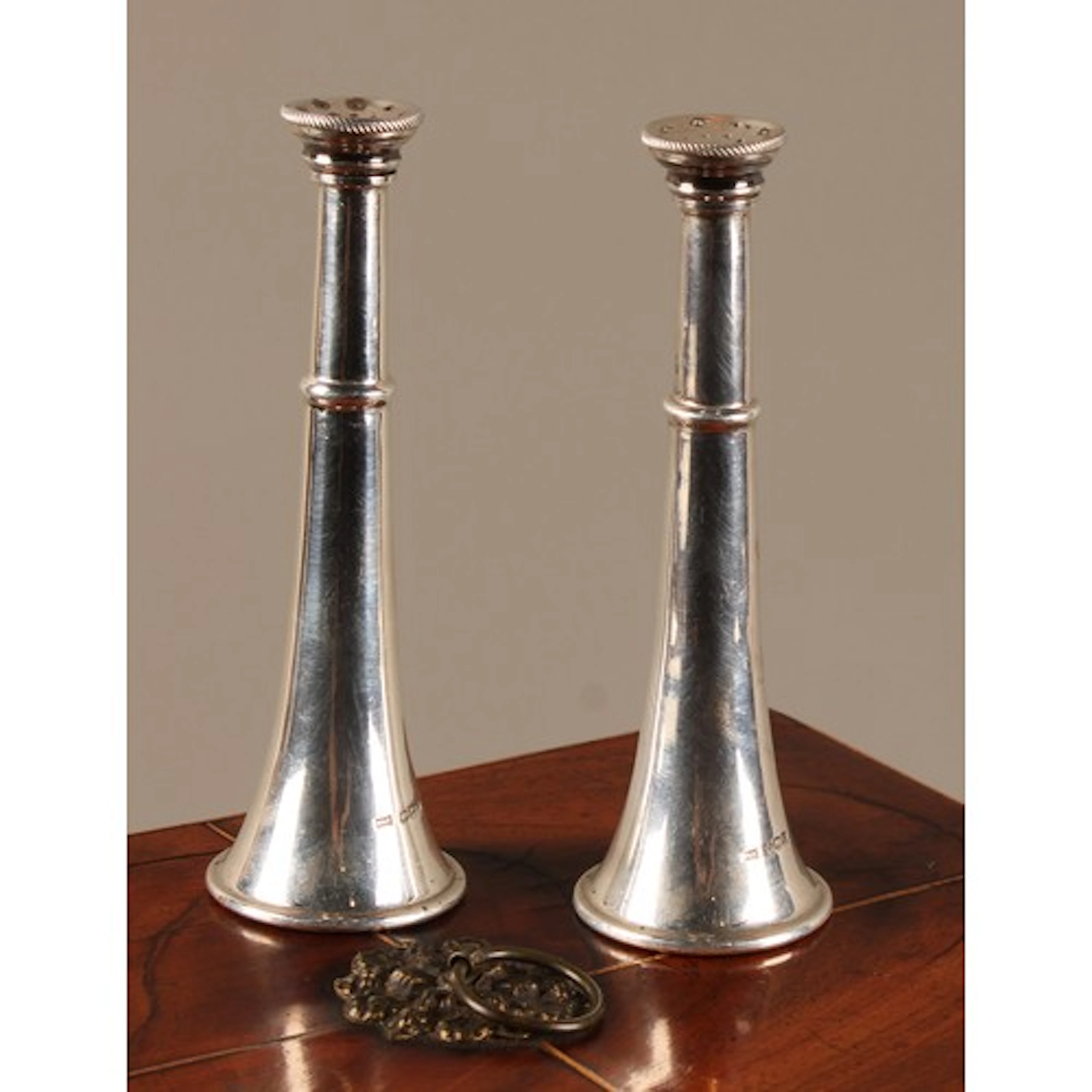 A pair of George V silver novelty peppers, as hunting horns,...