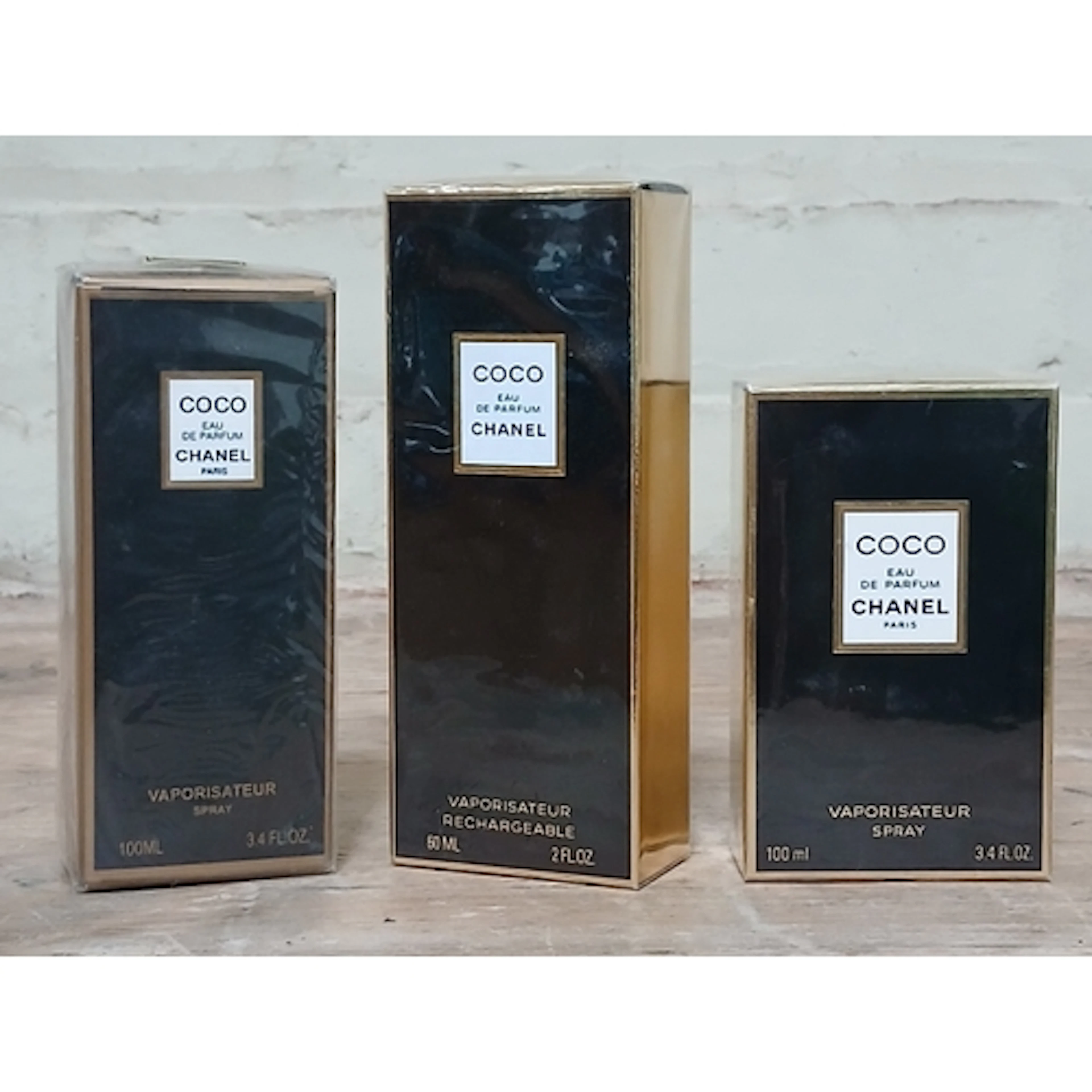 Coco Chanel, three sealed bottles of perfume.