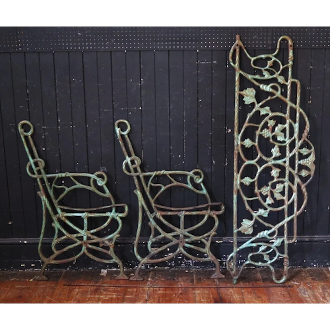 A pair of cast iron bench ends, of scrolling form with match...